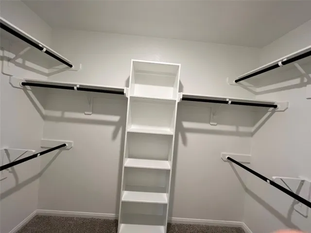 a bathroom with a double vanity sink a toilet and shower