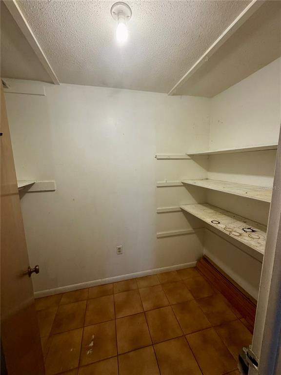 2929 West Oak Ridge Road, Unit F4 Orlando, FL 32809 - Photo 7 of 20 a storage room with an empty space