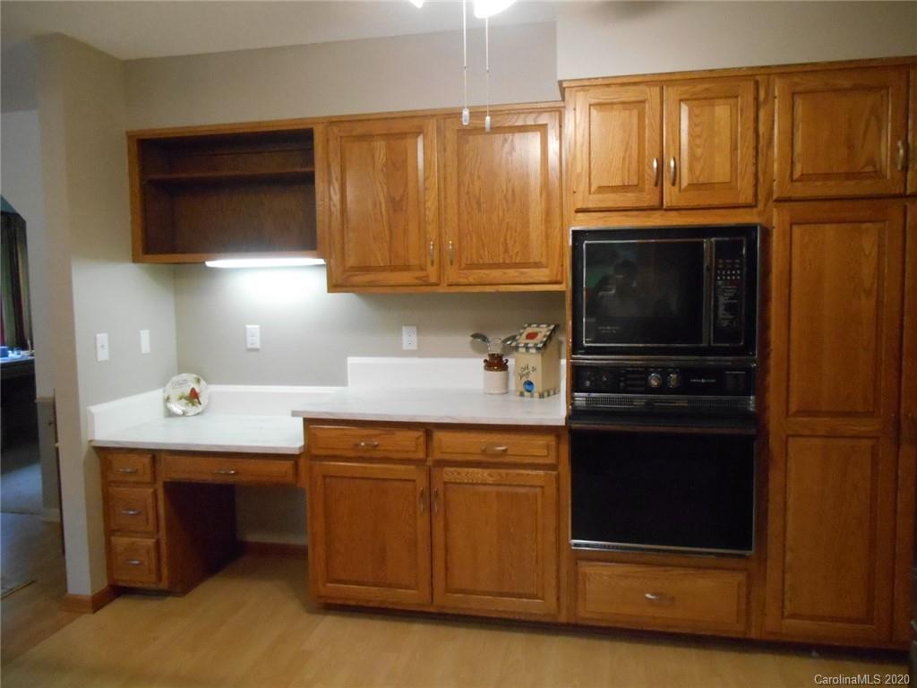 724 Laurel Ridge Road Columbus, NC 28722 - Photo 9 of 15 a kitchen with stainless steel appliances granite countertop a refrigerator stove and sink