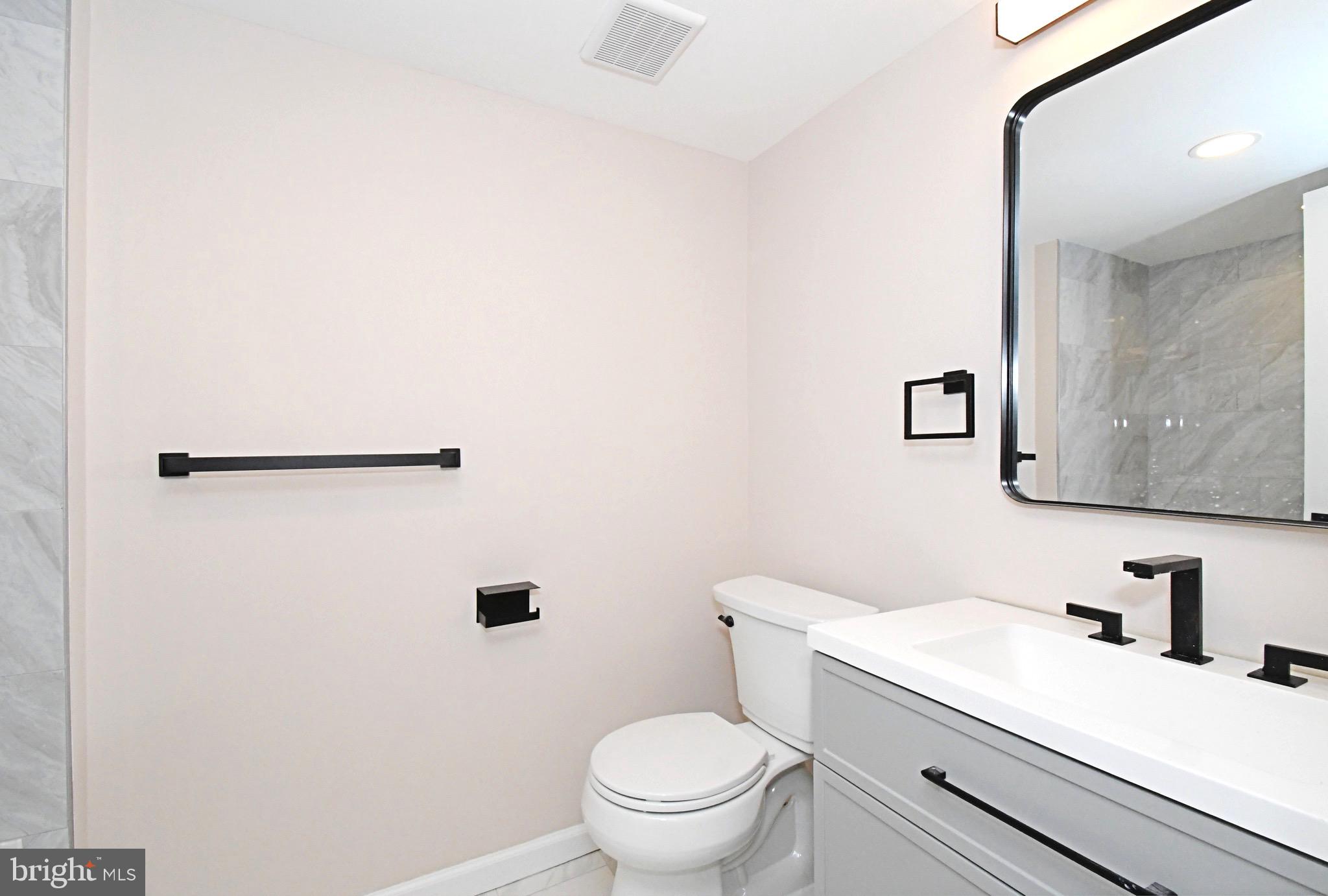 613 Washington Place, Unit 13 Chesterbrook, PA 19087 - Photo 12 of 64 a bathroom with a sink a toilet and a mirror