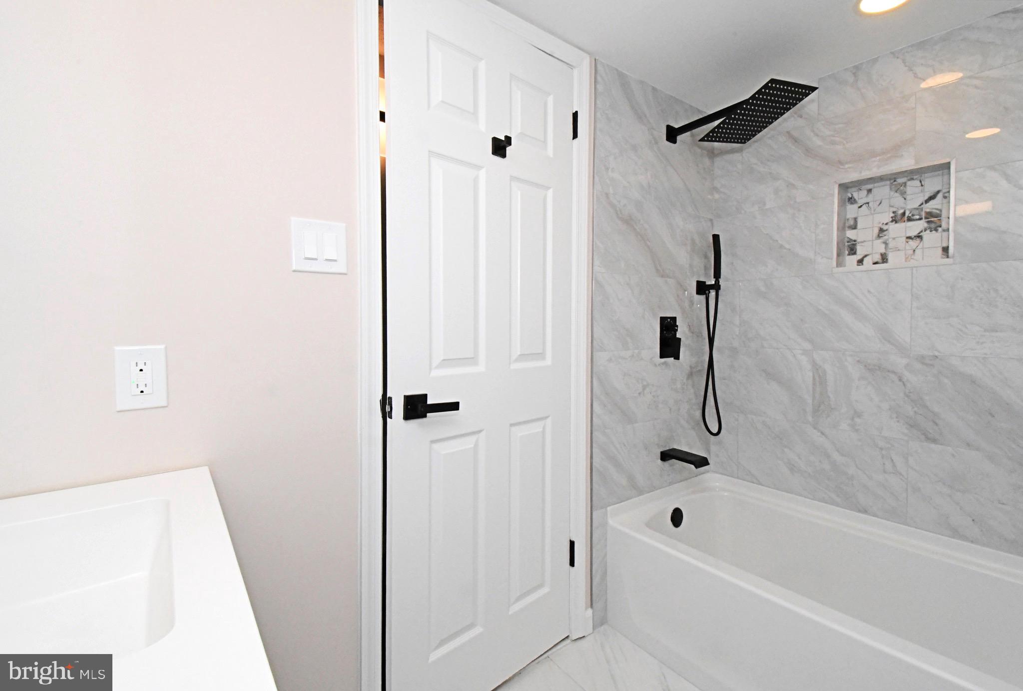 613 Washington Place, Unit 13 Chesterbrook, PA 19087 - Photo 13 of 64 a bathroom with a tub shower and a sink