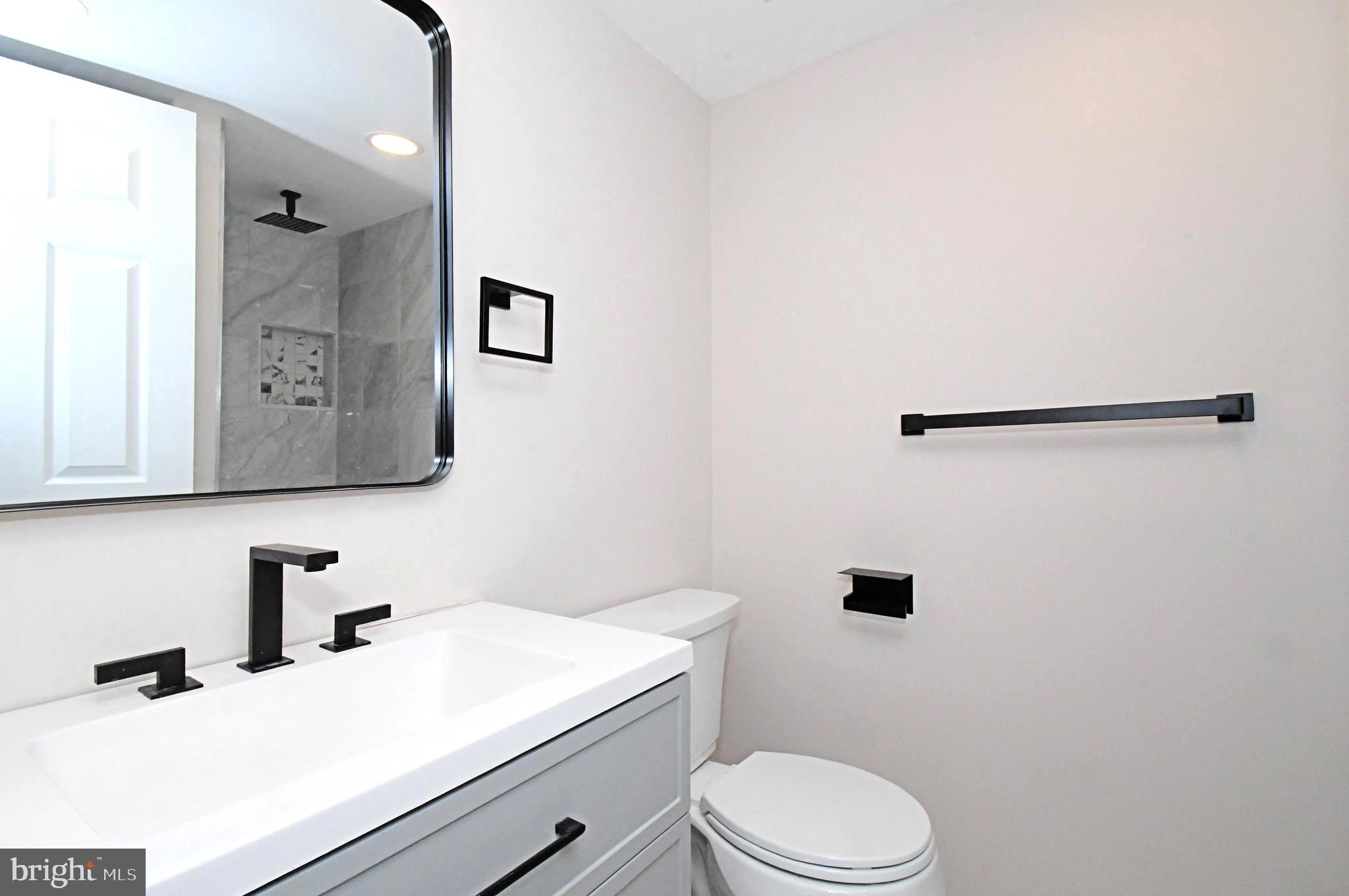 613 Washington Place, Unit 13 Chesterbrook, PA 19087 - Photo 16 of 64 a bathroom with a sink vanity mirror and toilet