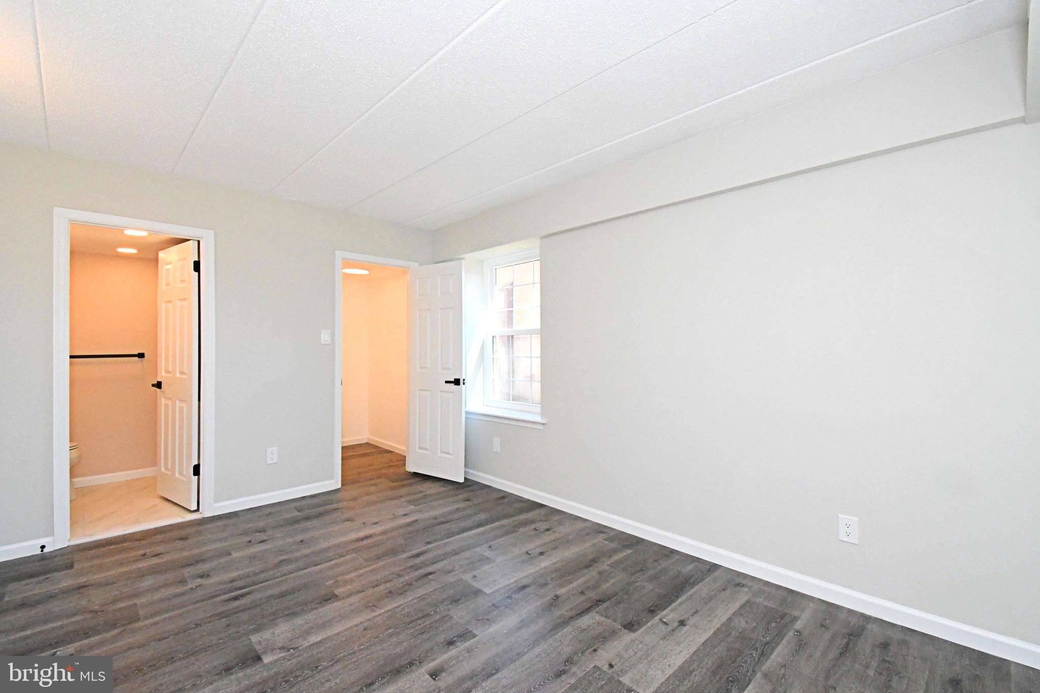 613 Washington Place, Unit 13 Chesterbrook, PA 19087 - Photo 22 of 64 an empty room with wooden floor and windows