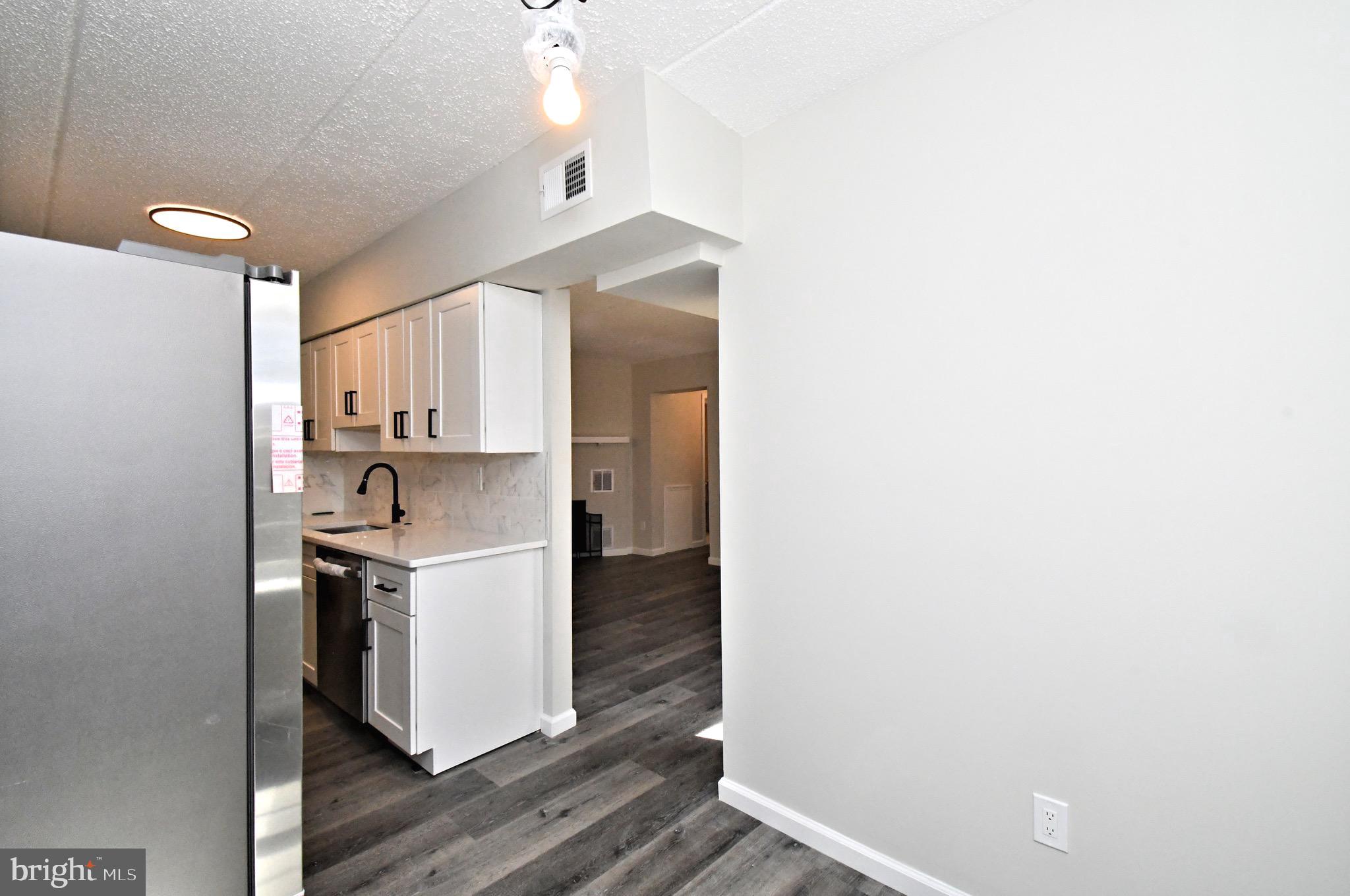 613 Washington Place, Unit 13 Chesterbrook, PA 19087 - Photo 24 of 64 a kitchen with a sink cabinets and wooden floor