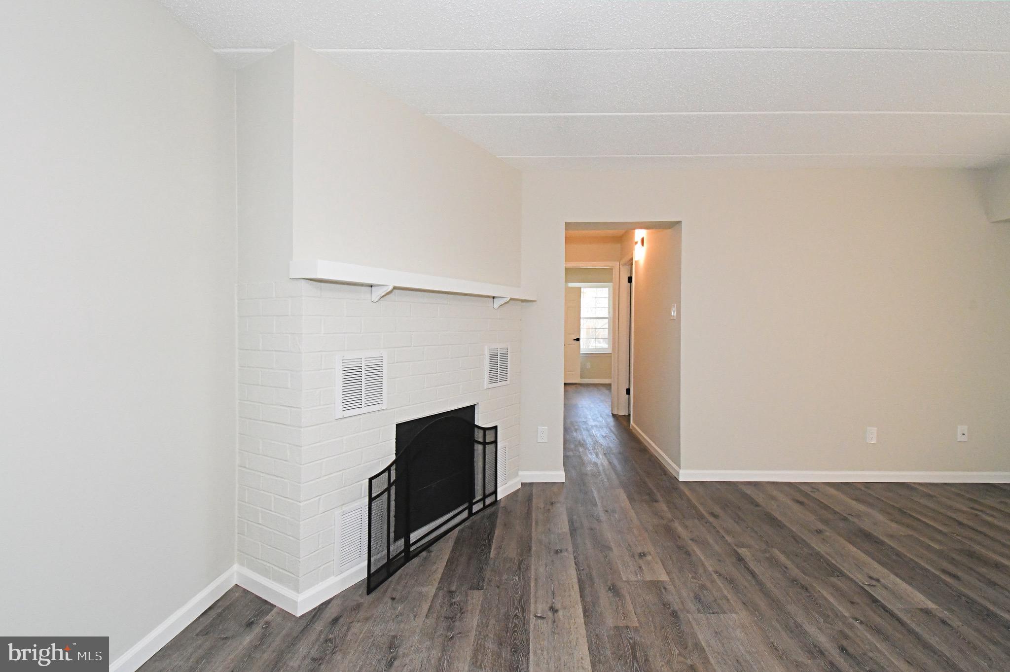 613 Washington Place, Unit 13 Chesterbrook, PA 19087 - Photo 25 of 64 a view of empty room with wooden floor and fireplace