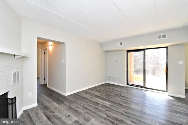 a kitchen with stainless steel appliances white cabinets a sink and a large window