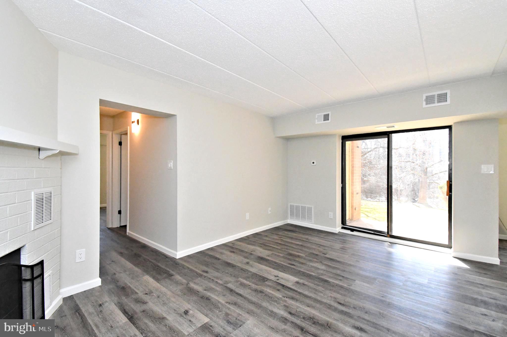 613 Washington Place, Unit 13 Chesterbrook, PA 19087 - Photo 26 of 64 a view of an empty room with wooden floor and a window