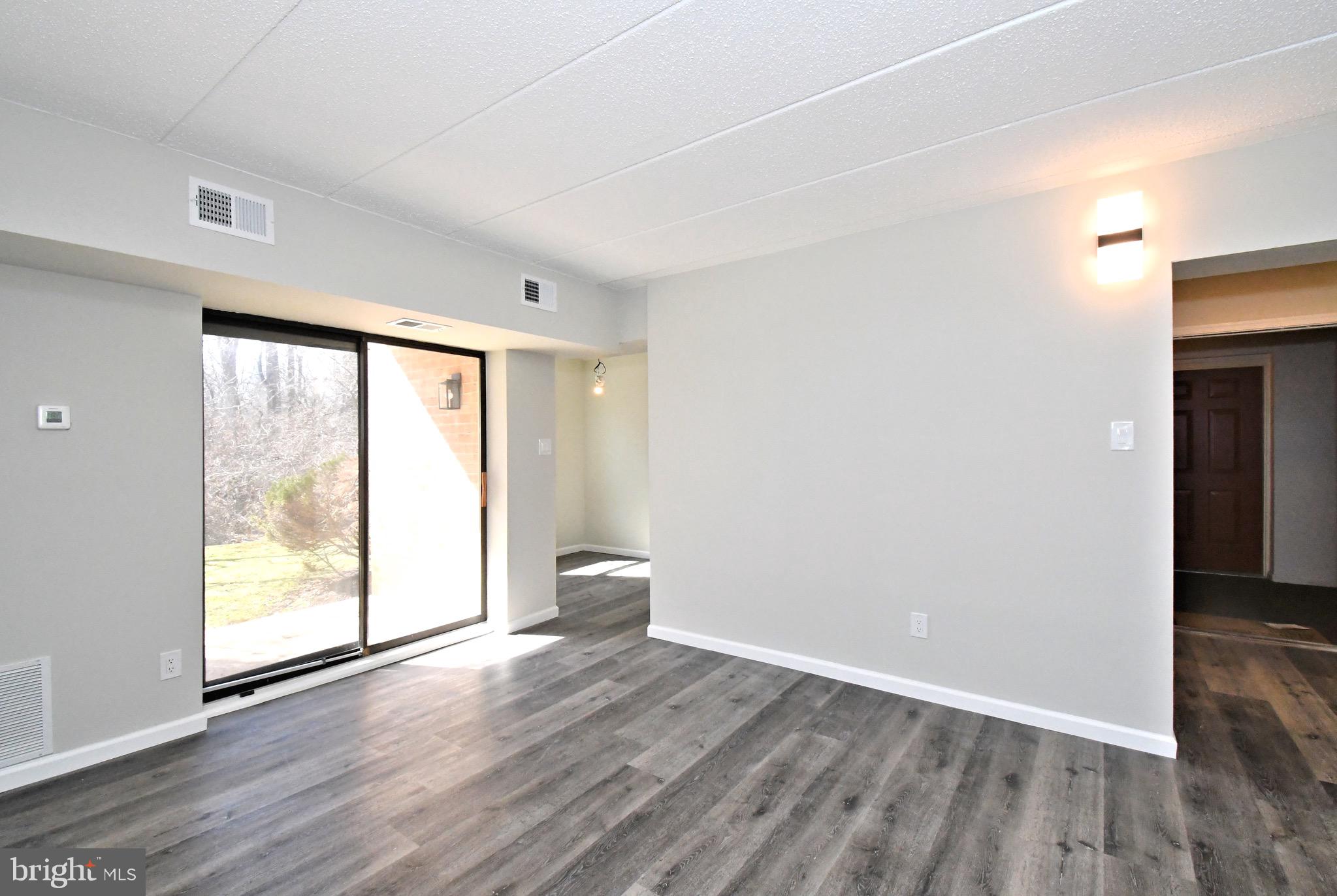 613 Washington Place, Unit 13 Chesterbrook, PA 19087 - Photo 27 of 64 an empty room with wooden floor and windows