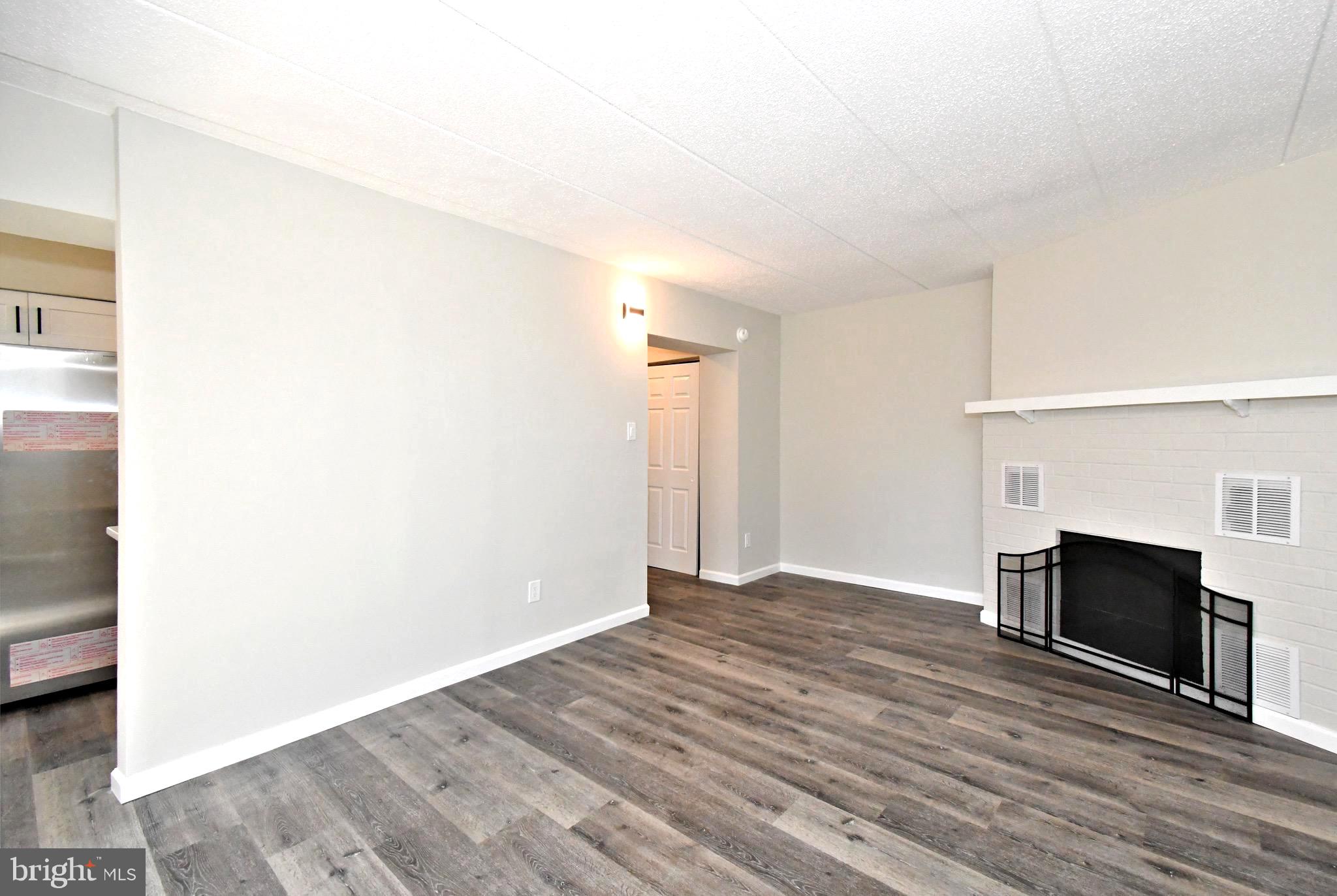 613 Washington Place, Unit 13 Chesterbrook, PA 19087 - Photo 28 of 64 a view of empty room with wooden floor and fireplace