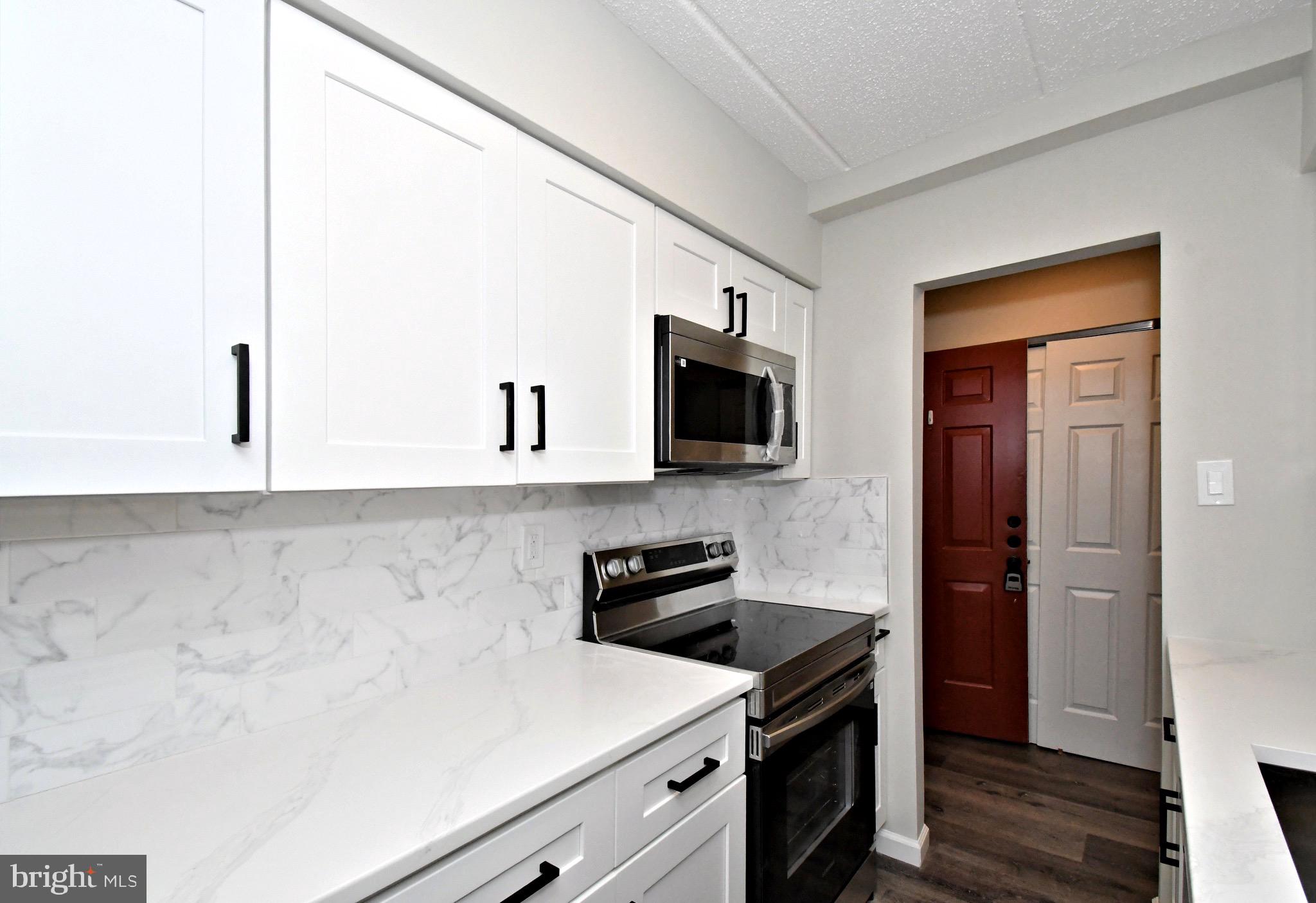 613 Washington Place, Unit 13 Chesterbrook, PA 19087 - Photo 30 of 64 a kitchen with a sink and a stove top oven