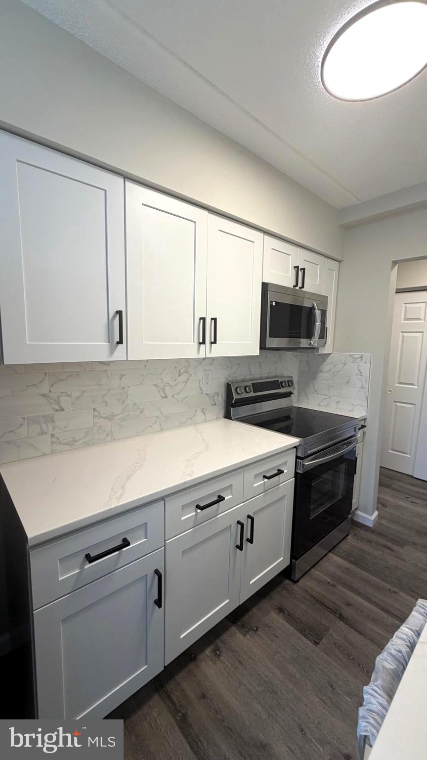 613 Washington Place, Unit 13 Chesterbrook, PA 19087 - Photo 32 of 64 a kitchen with appliances cabinets and a sink