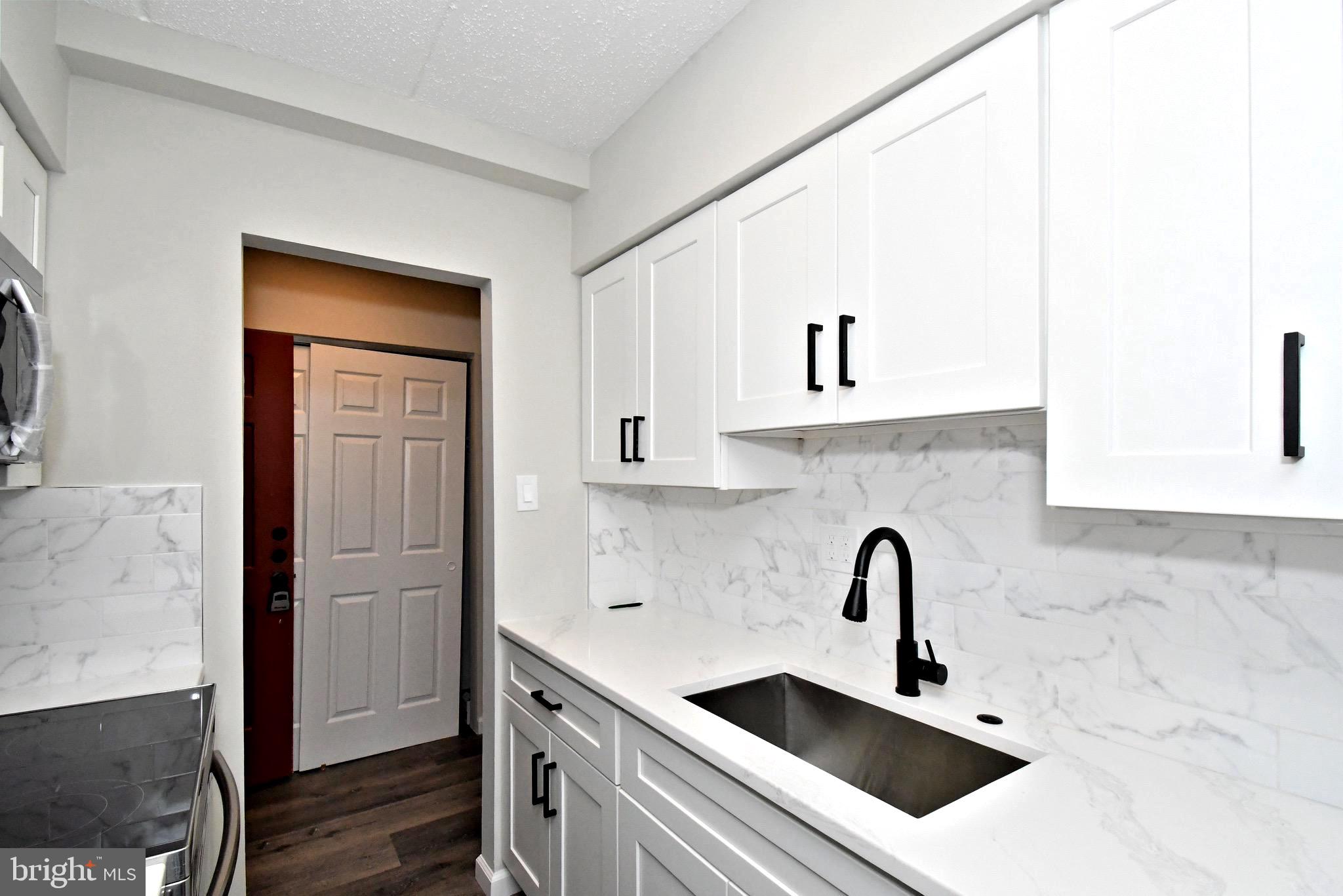 613 Washington Place, Unit 13 Chesterbrook, PA 19087 - Photo 34 of 64 a kitchen with stainless steel appliances a sink and cabinets