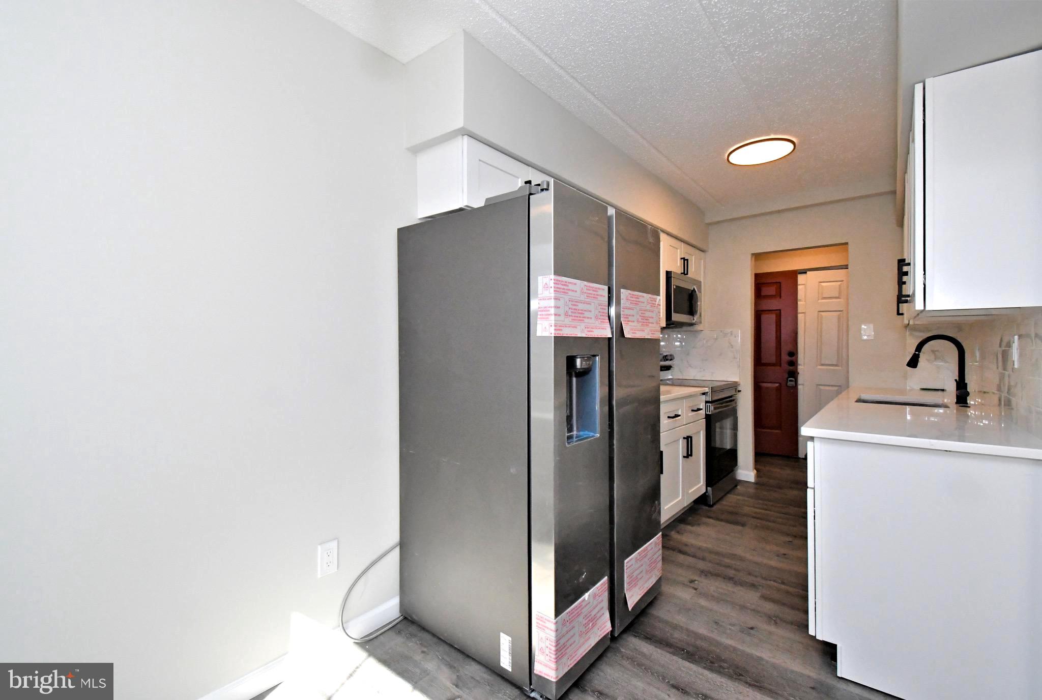 613 Washington Place, Unit 13 Chesterbrook, PA 19087 - Photo 38 of 64 a kitchen with stainless steel appliances a refrigerator and a sink