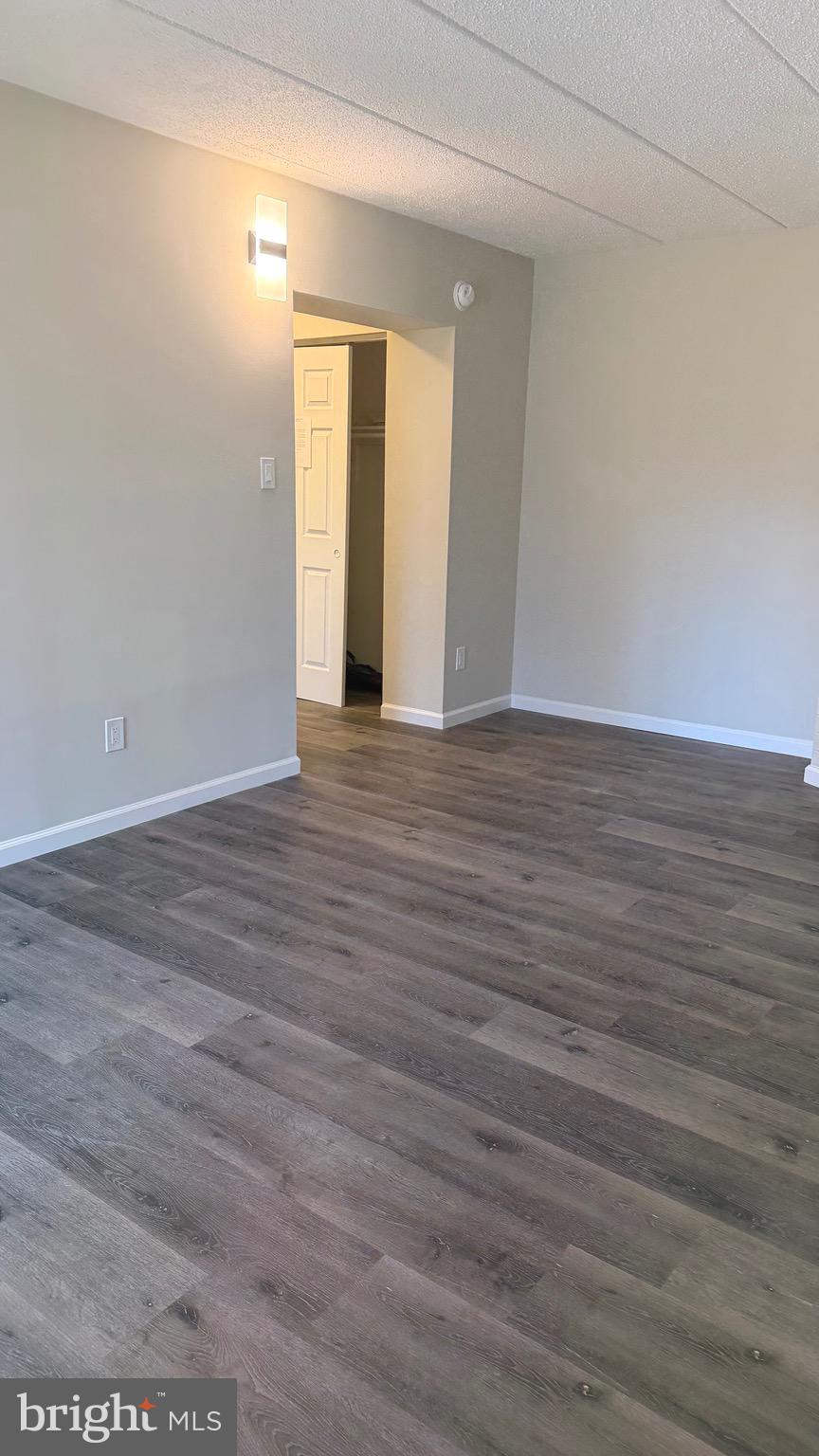 613 Washington Place, Unit 13 Chesterbrook, PA 19087 - Photo 49 of 64 a view of an empty room with wooden floor and a window