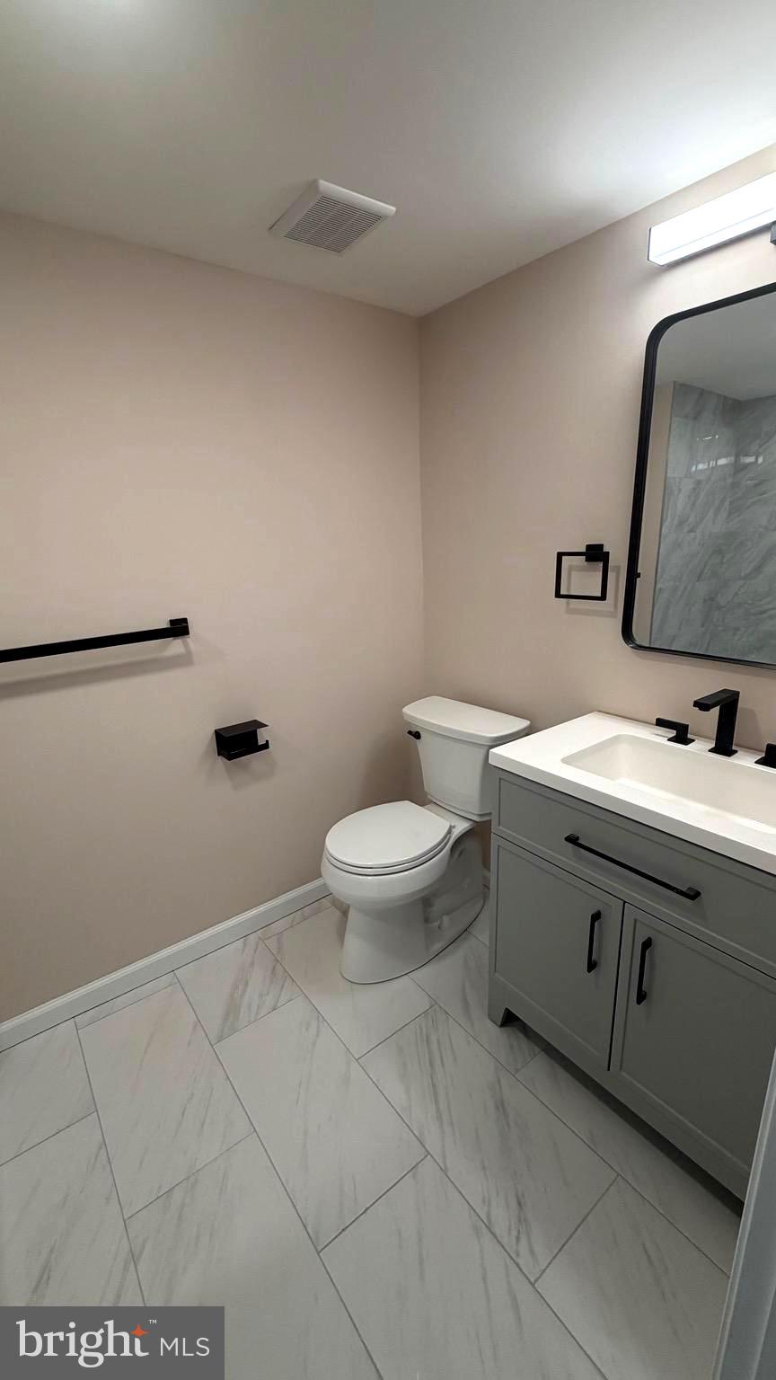 613 Washington Place, Unit 13 Chesterbrook, PA 19087 - Photo 57 of 64 a bathroom with a toilet sink and mirror