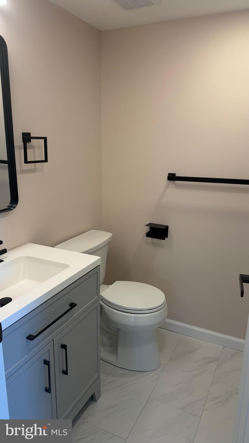 613 Washington Place, Unit 13 Chesterbrook, PA 19087 - Photo 62 of 64 a bathroom with a sink a toilet and mirror