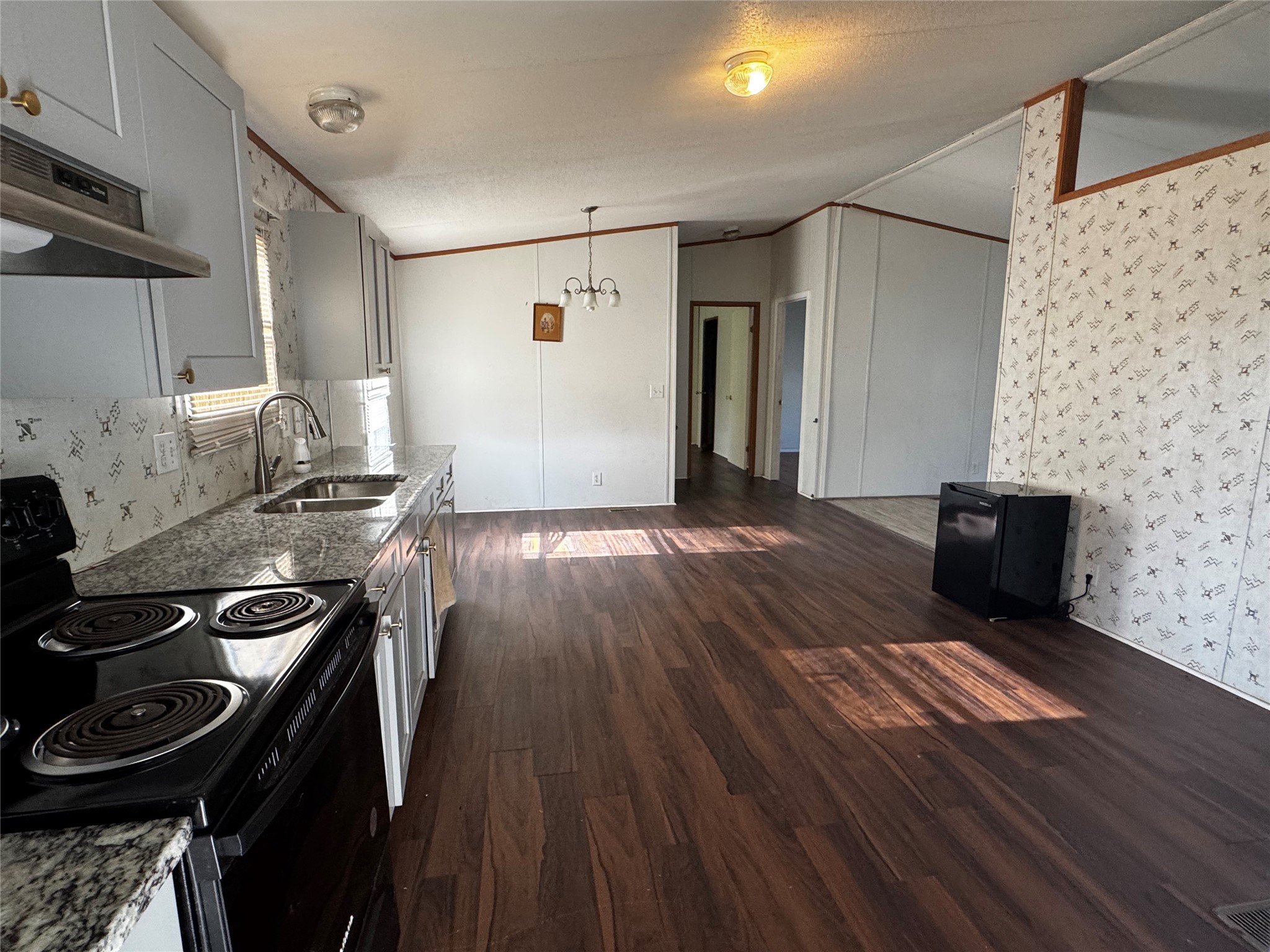 15930 Boss Gaston Road Sugar Land, TX 77498 - Photo 3 of 20 a kitchen with a wooden floor and a stove top oven