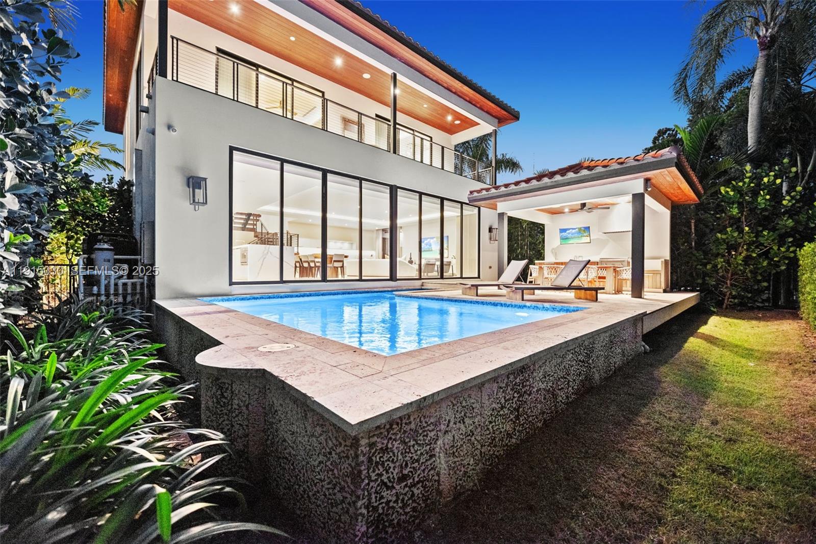 a view of a house with swimming pool and sitting area