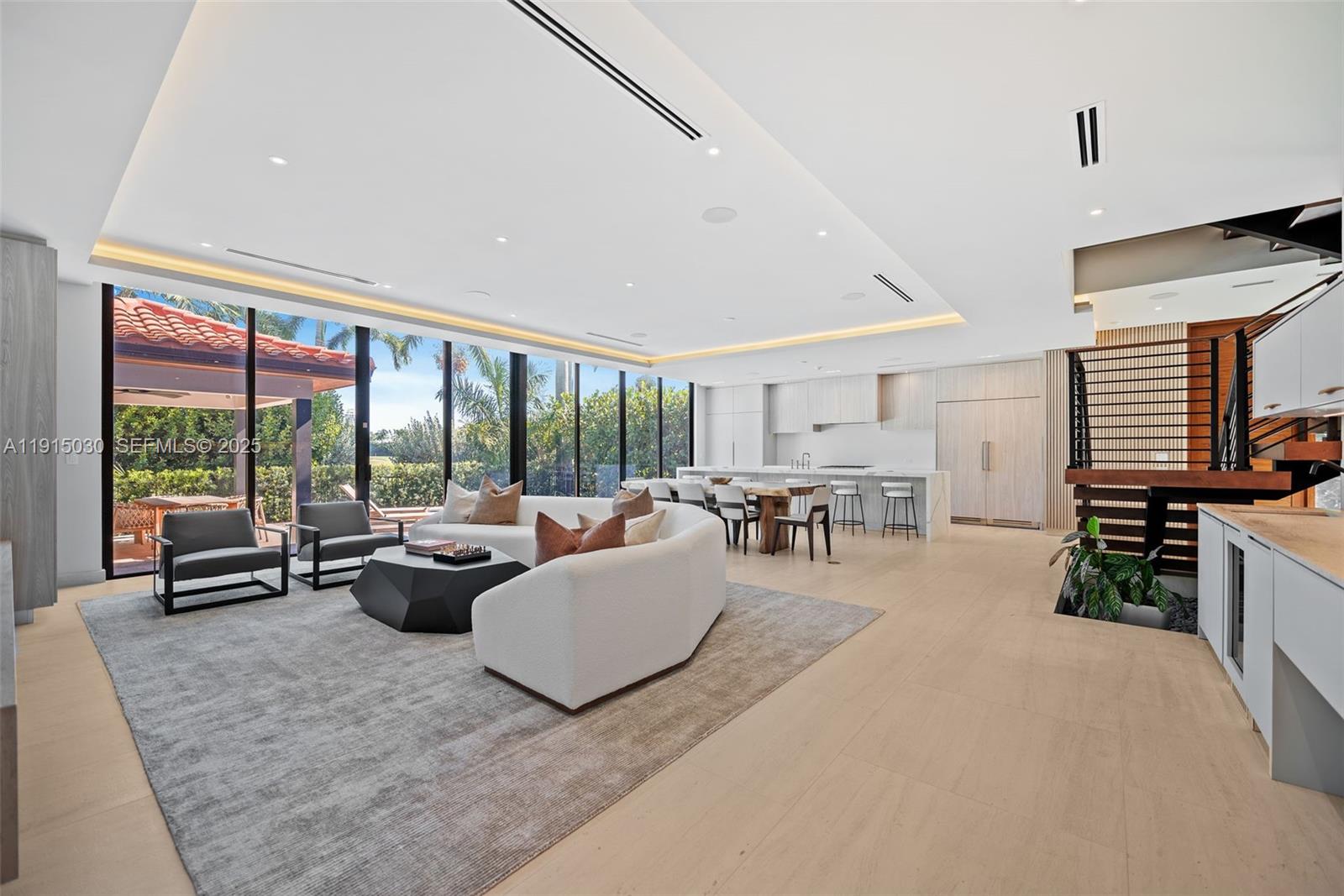 5831 Alton Road Miami Beach, FL 33140 - Photo 11 of 48 a living room with furniture and a flat screen tv