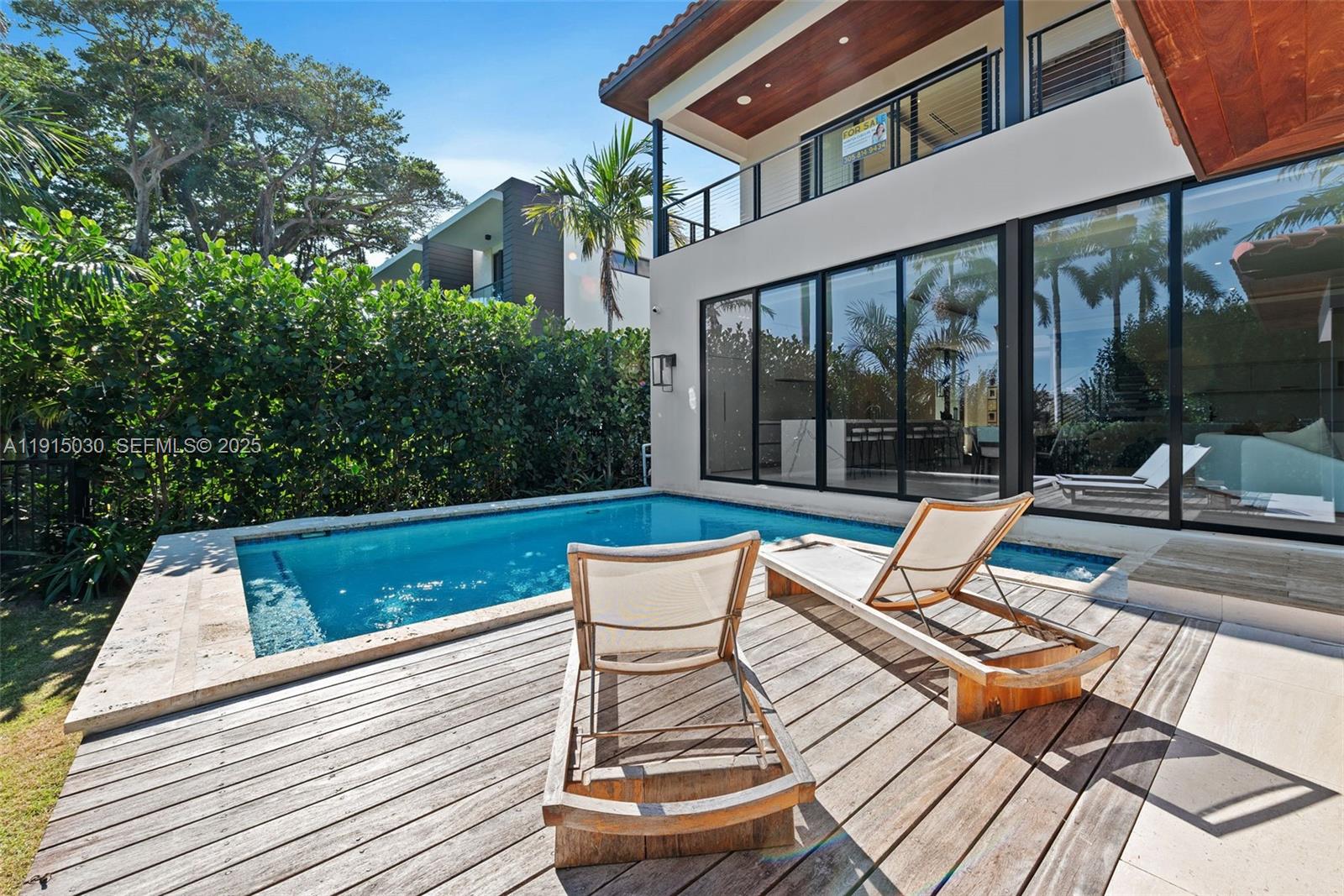 5831 Alton Road Miami Beach, FL 33140 - Photo 16 of 48 a view of a patio with a dining table and chairs with wooden floor