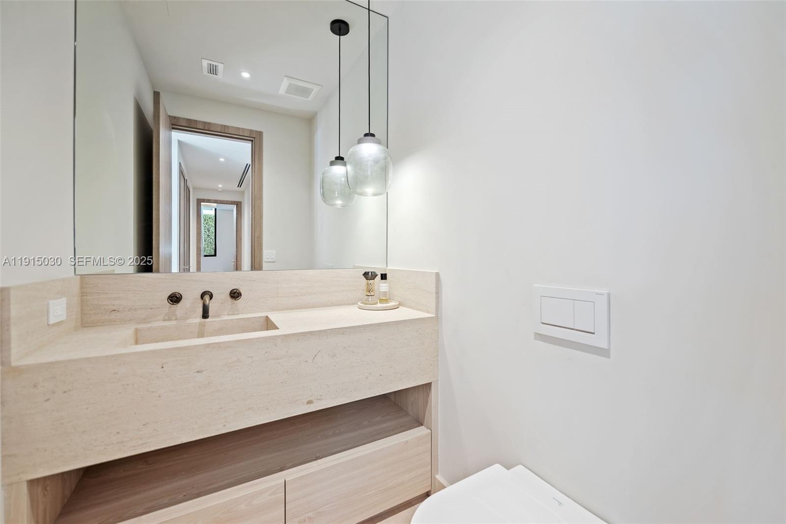 5831 Alton Road Miami Beach, FL 33140 - Photo 23 of 48 a bathroom with a sink and a mirror