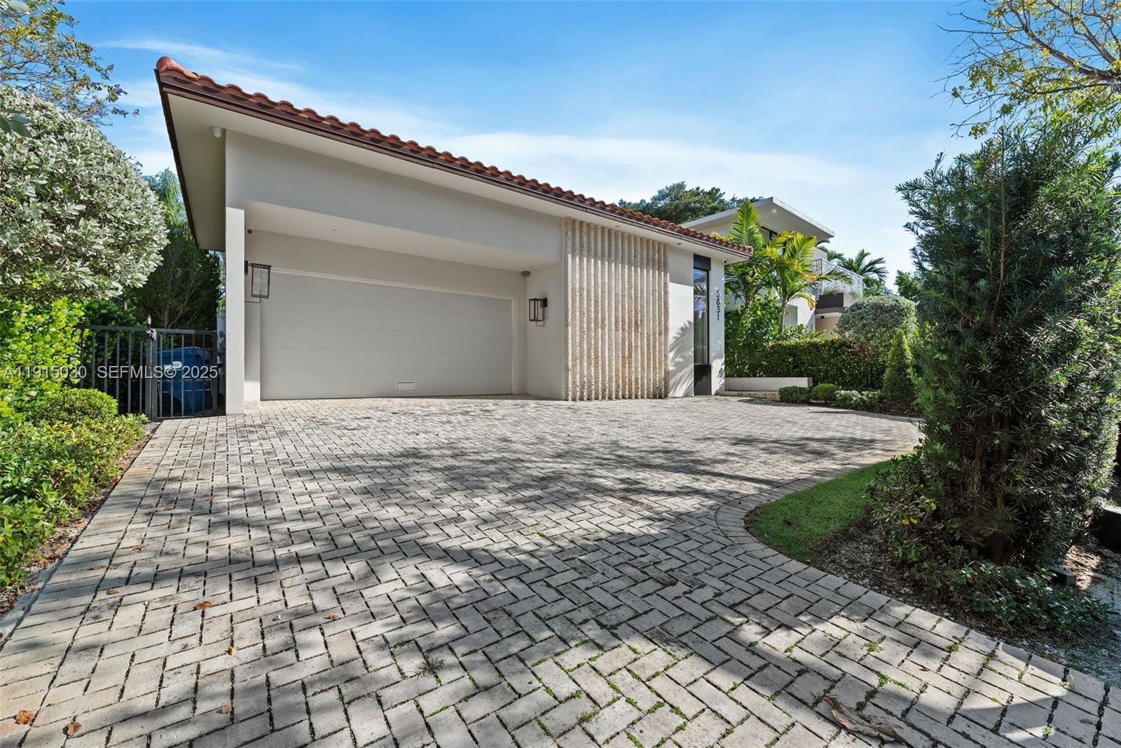 5831 Alton Road Miami Beach, FL 33140 - Photo 25 of 48 a front view of a house with a yard
