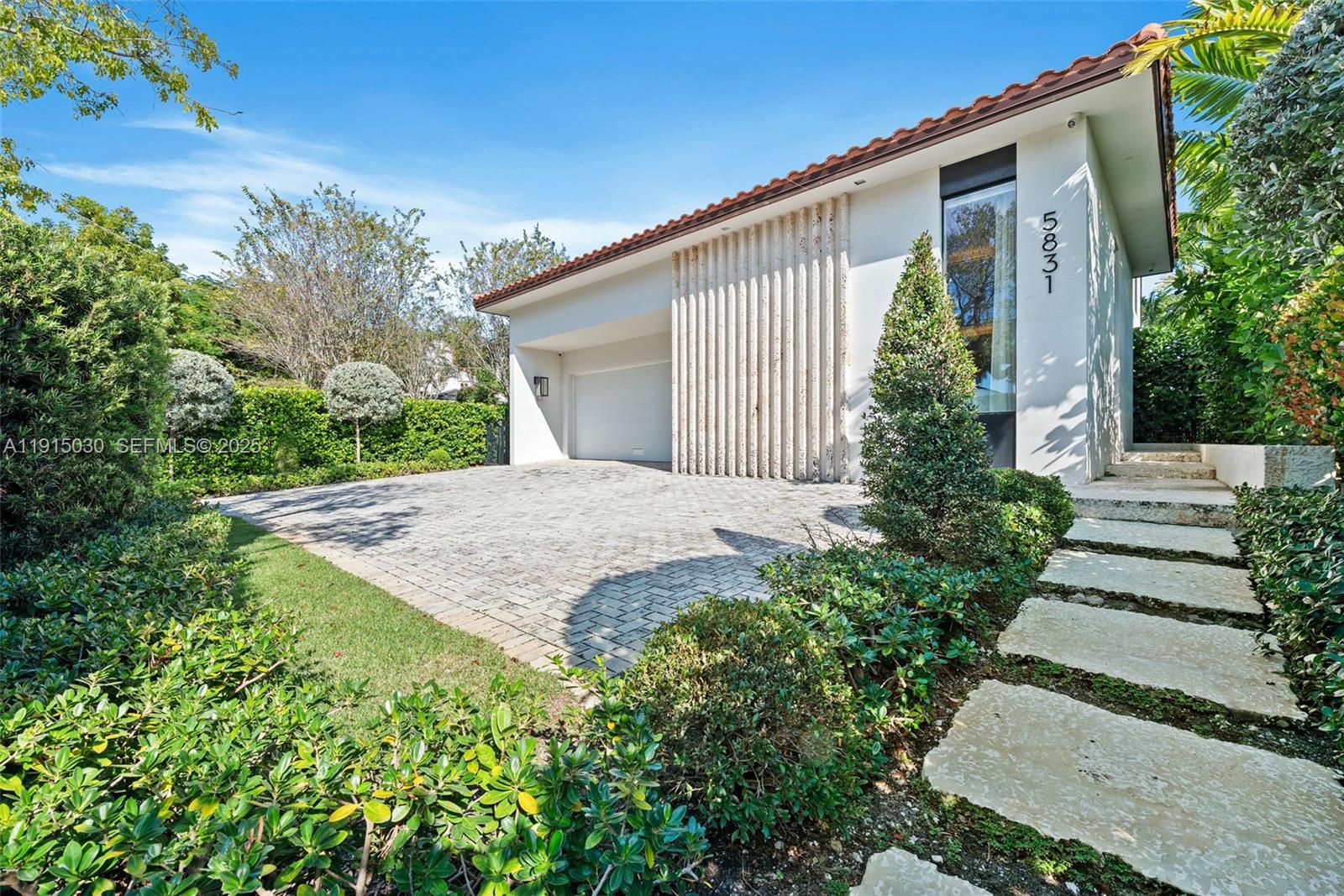 5831 Alton Road Miami Beach, FL 33140 - Photo 29 of 48 a front view of a house with garden