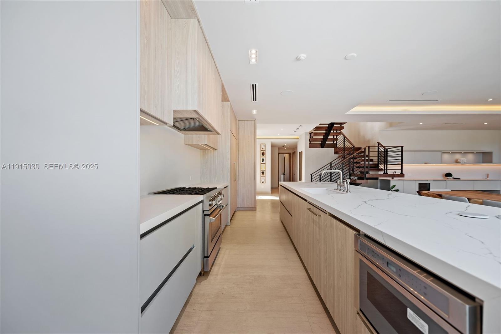 5831 Alton Road Miami Beach, FL 33140 - Photo 30 of 48 a kitchen with refrigerator and cabinets