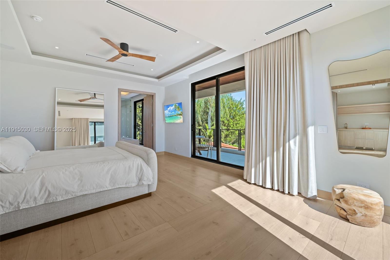 5831 Alton Road Miami Beach, FL 33140 - Photo 35 of 48 a bedroom with a bed and a large window