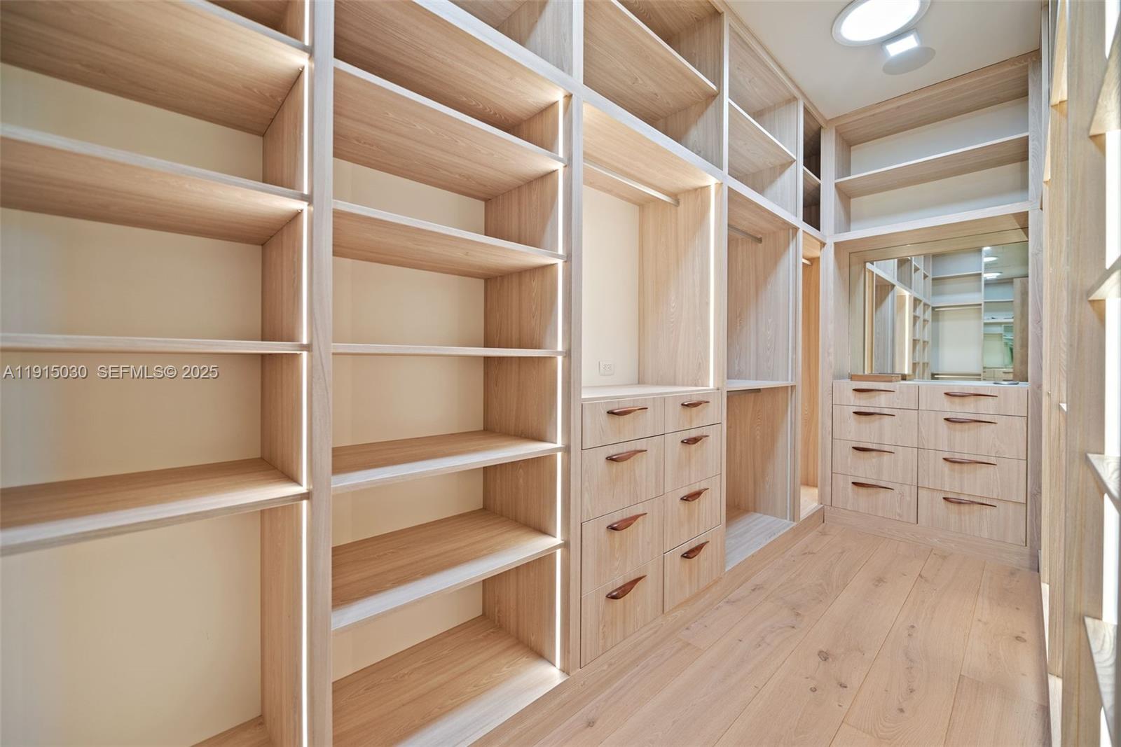 5831 Alton Road Miami Beach, FL 33140 - Photo 38 of 48 a view of walk in closet with empty racks