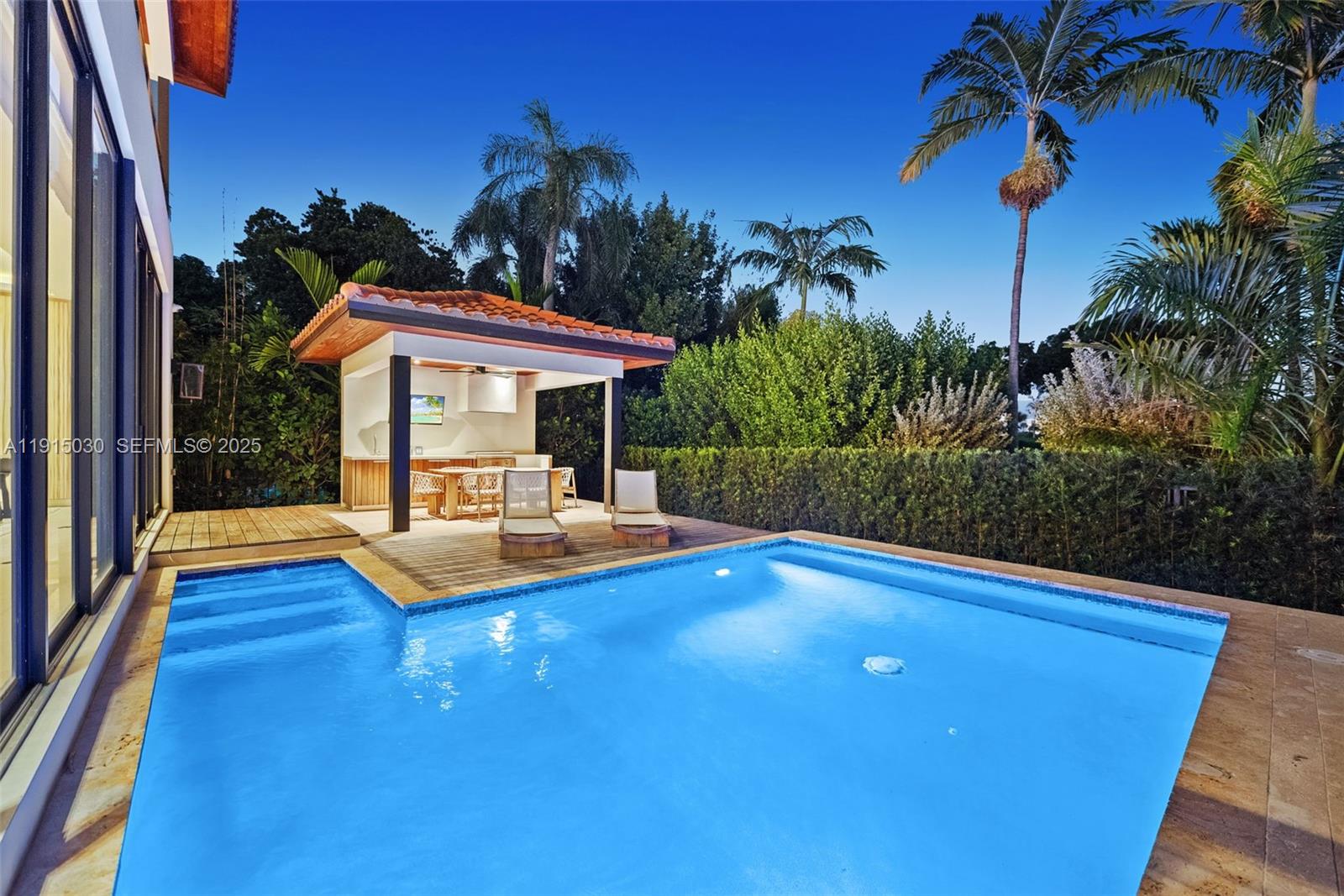 5831 Alton Road Miami Beach, FL 33140 - Photo 4 of 48 a view of a swimming pool with a patio