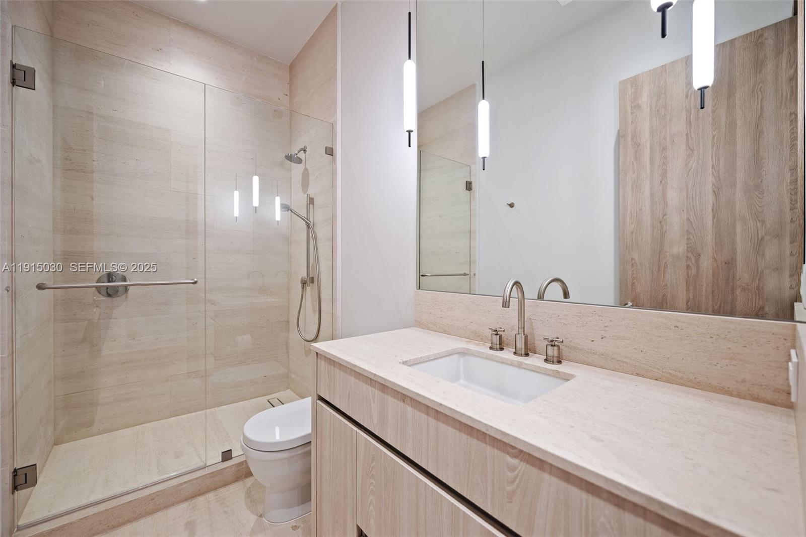 5831 Alton Road Miami Beach, FL 33140 - Photo 42 of 48 a bathroom with a sink a toilet and shower