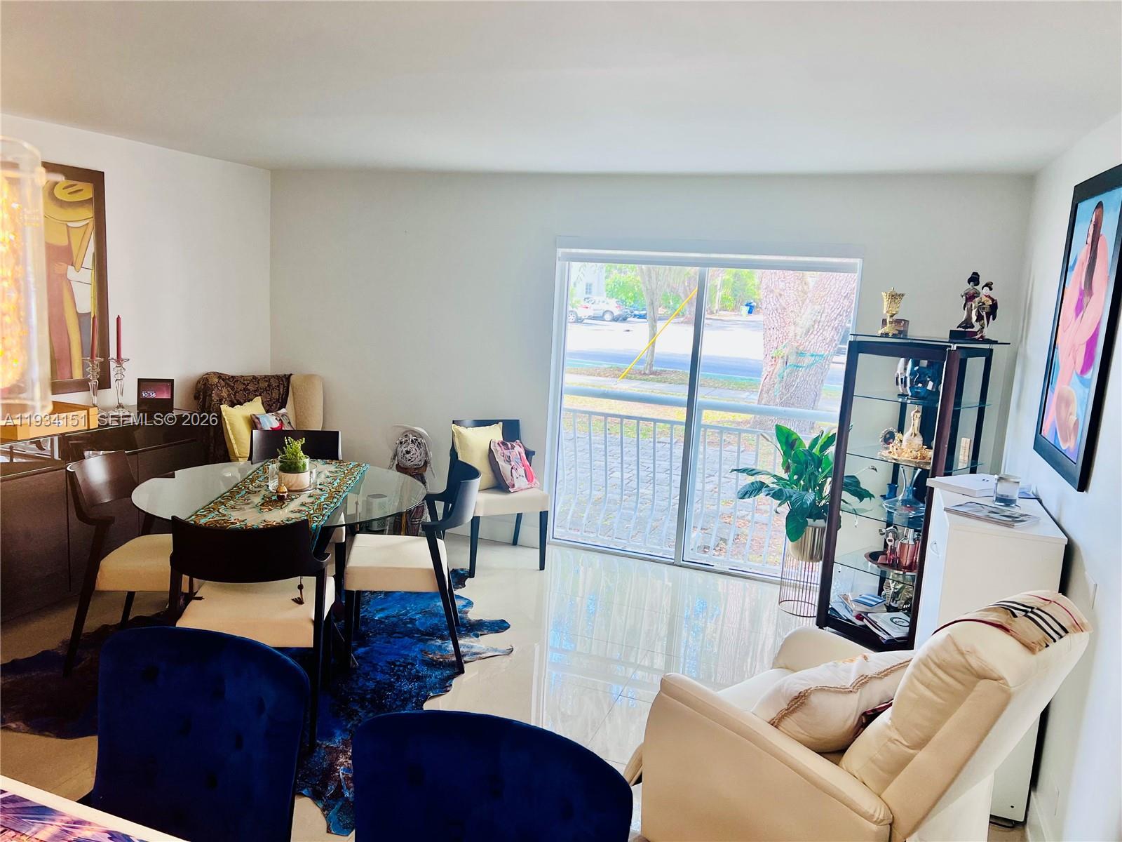 3101 Southwest 27th Avenue, Unit 101 Miami, FL 33133 - Photo 5 of 11 a living room with furniture a large window and wooden floor