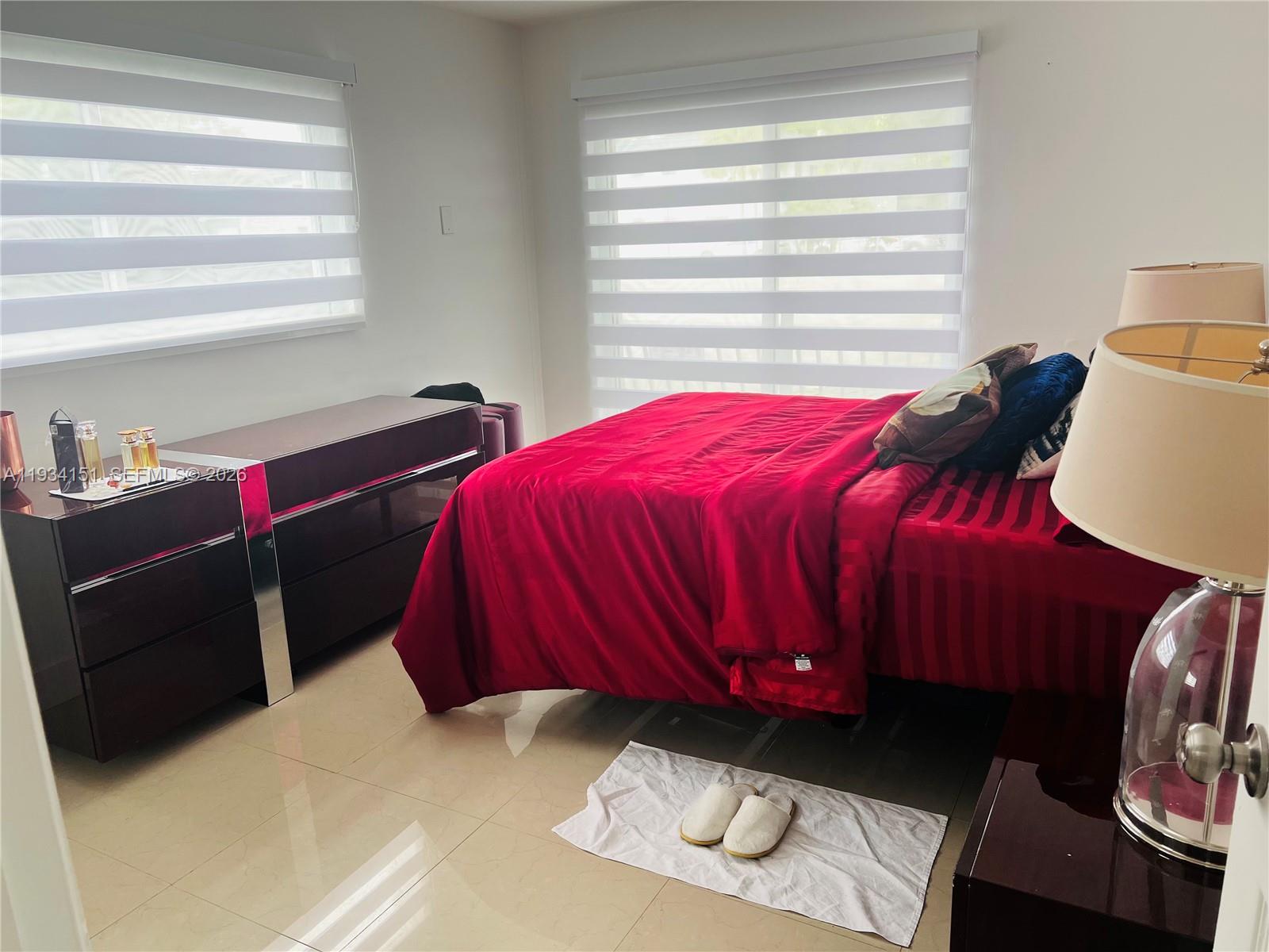 3101 Southwest 27th Avenue, Unit 101 Miami, FL 33133 - Photo 8 of 11 a bedroom with a bed and a window