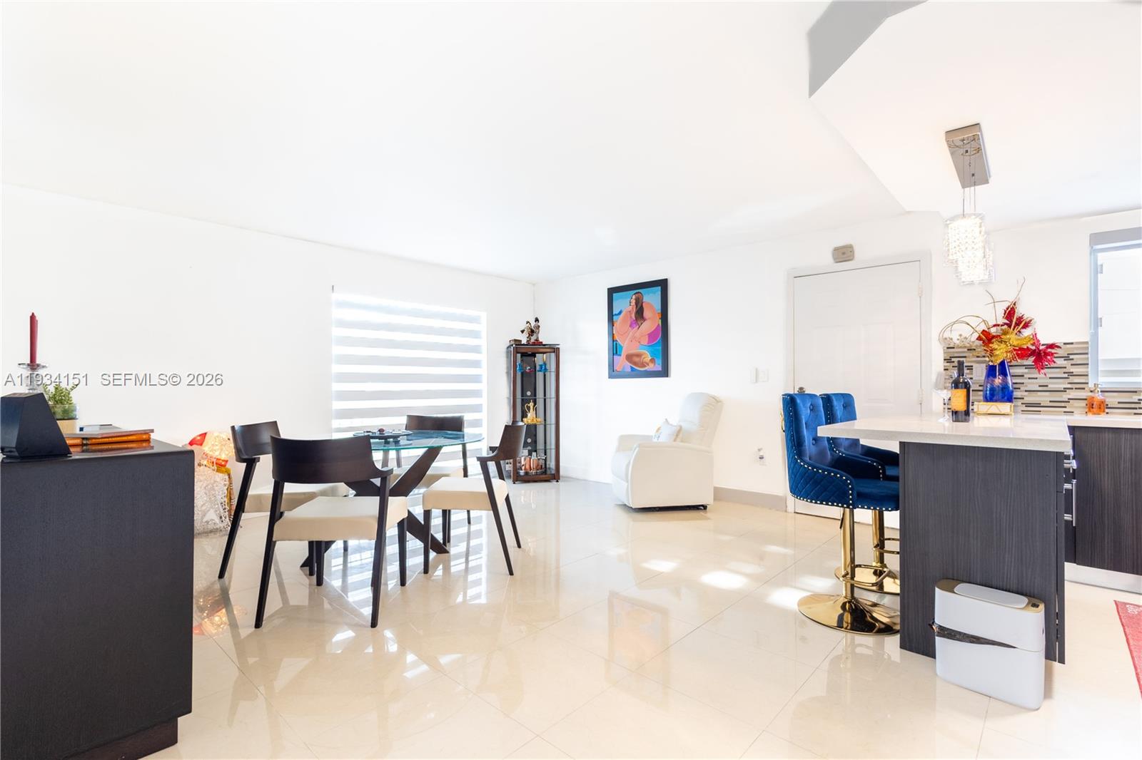 3101 Southwest 27th Avenue, Unit 101 Miami, FL 33133 - Photo 9 of 11 a dining room with furniture and a kitchen view