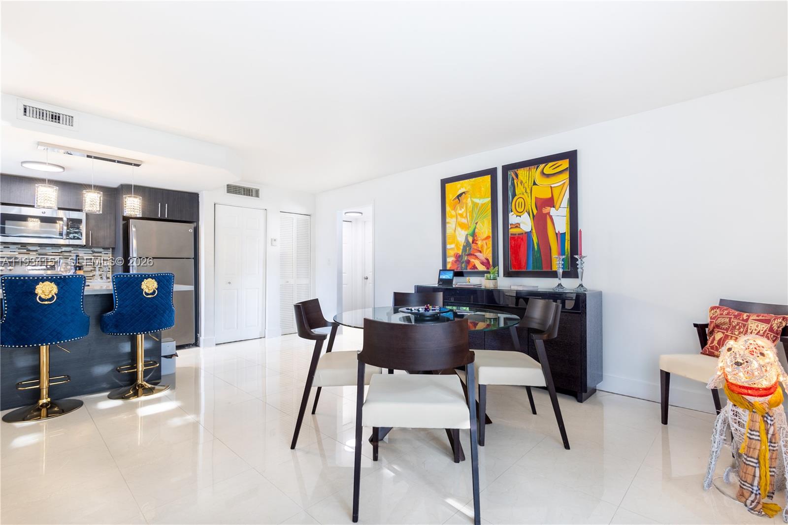 3101 Southwest 27th Avenue, Unit 101 Miami, FL 33133 - Photo 10 of 11 a view of a livingroom with furniture and a flat screen tv
