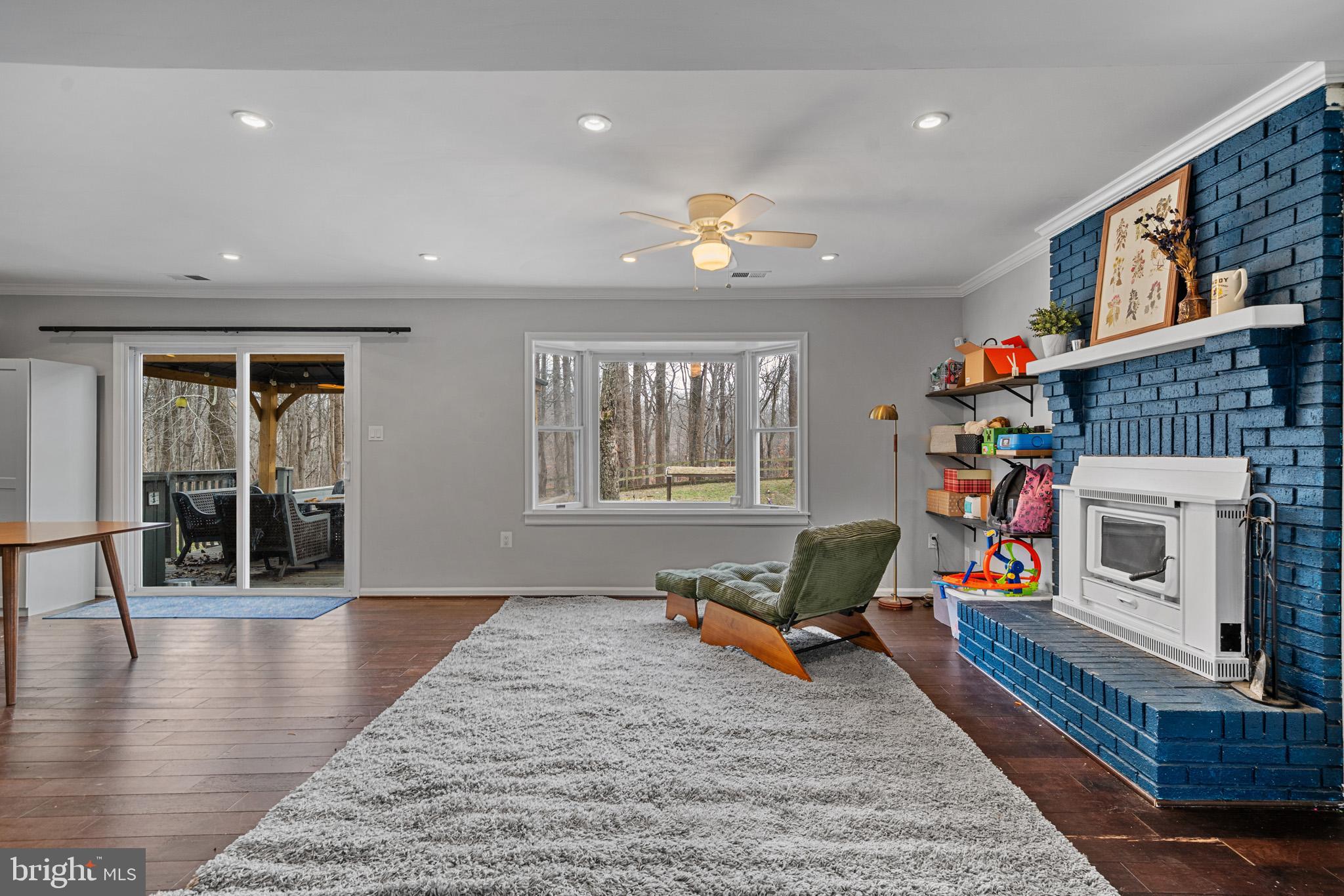 5918 Old Croom Station Road Upper Marlboro, MD 20772 - Photo 18 of 89 a living room with furniture wooden floor and a fireplace