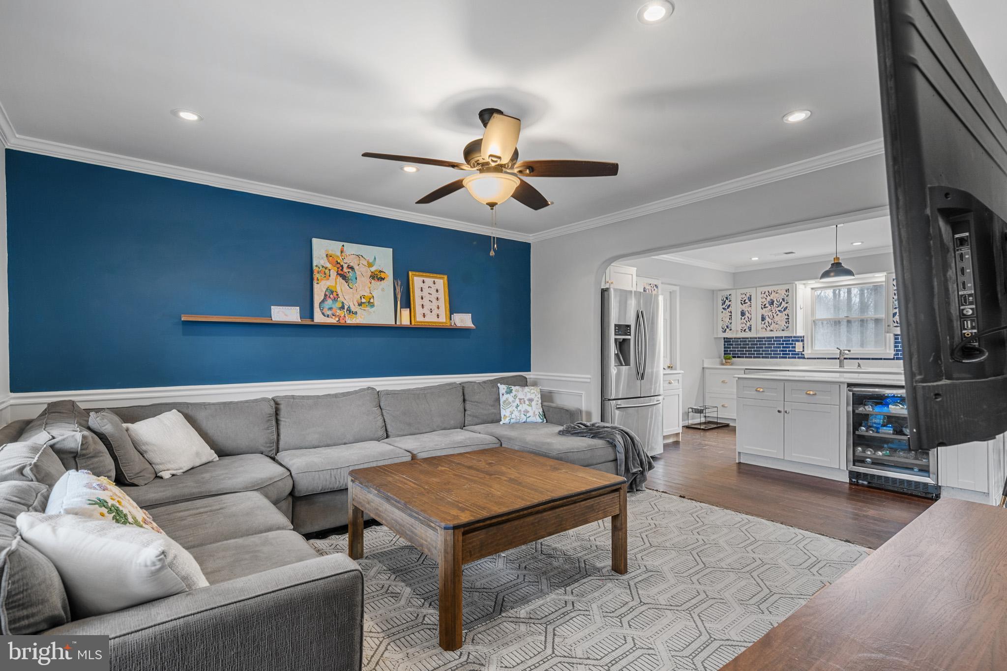 5918 Old Croom Station Road Upper Marlboro, MD 20772 - Photo 21 of 89 a living room with furniture a ceiling fan and a rug