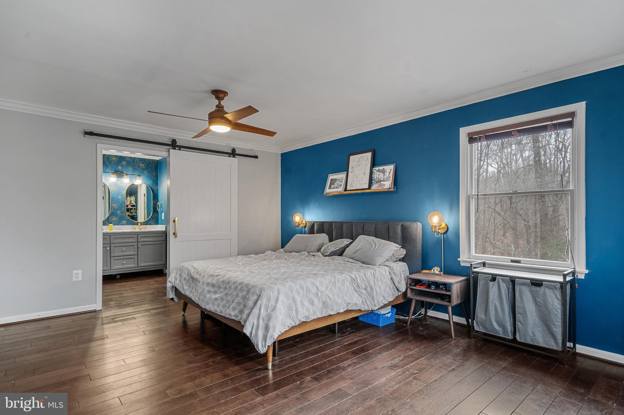 5918 Old Croom Station Road Upper Marlboro, MD 20772 - Photo 30 of 89 a bedroom with a bed and a chandelier