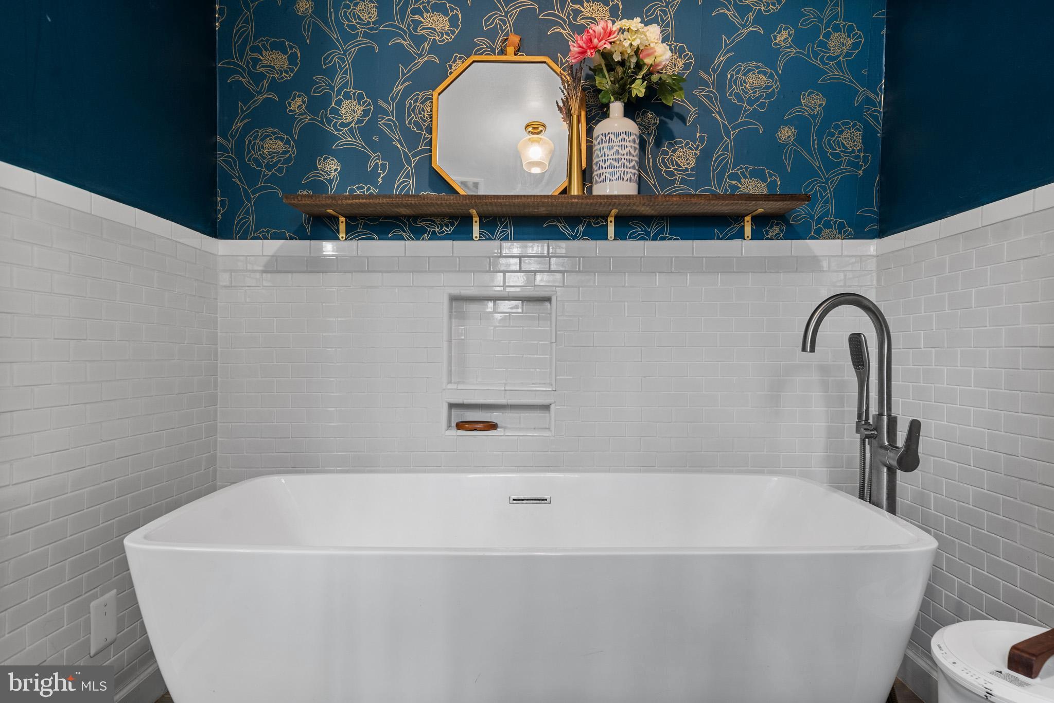 5918 Old Croom Station Road Upper Marlboro, MD 20772 - Photo 35 of 89 a bathroom with a sink a mirror and a bathtub