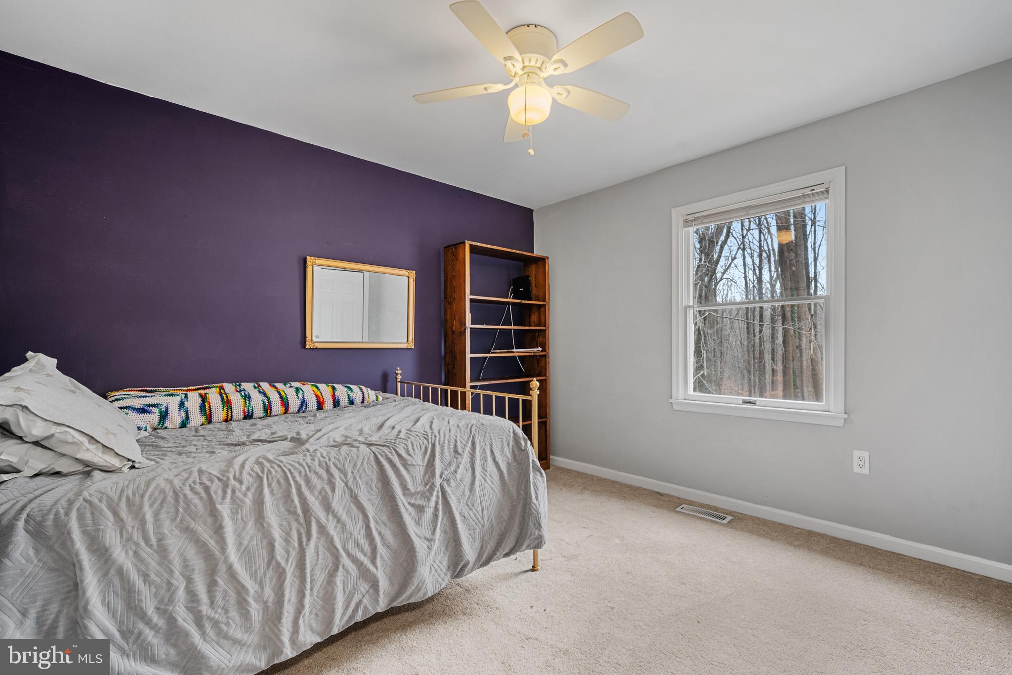 5918 Old Croom Station Road Upper Marlboro, MD 20772 - Photo 40 of 89 a bedroom with a bed and a chandelier
