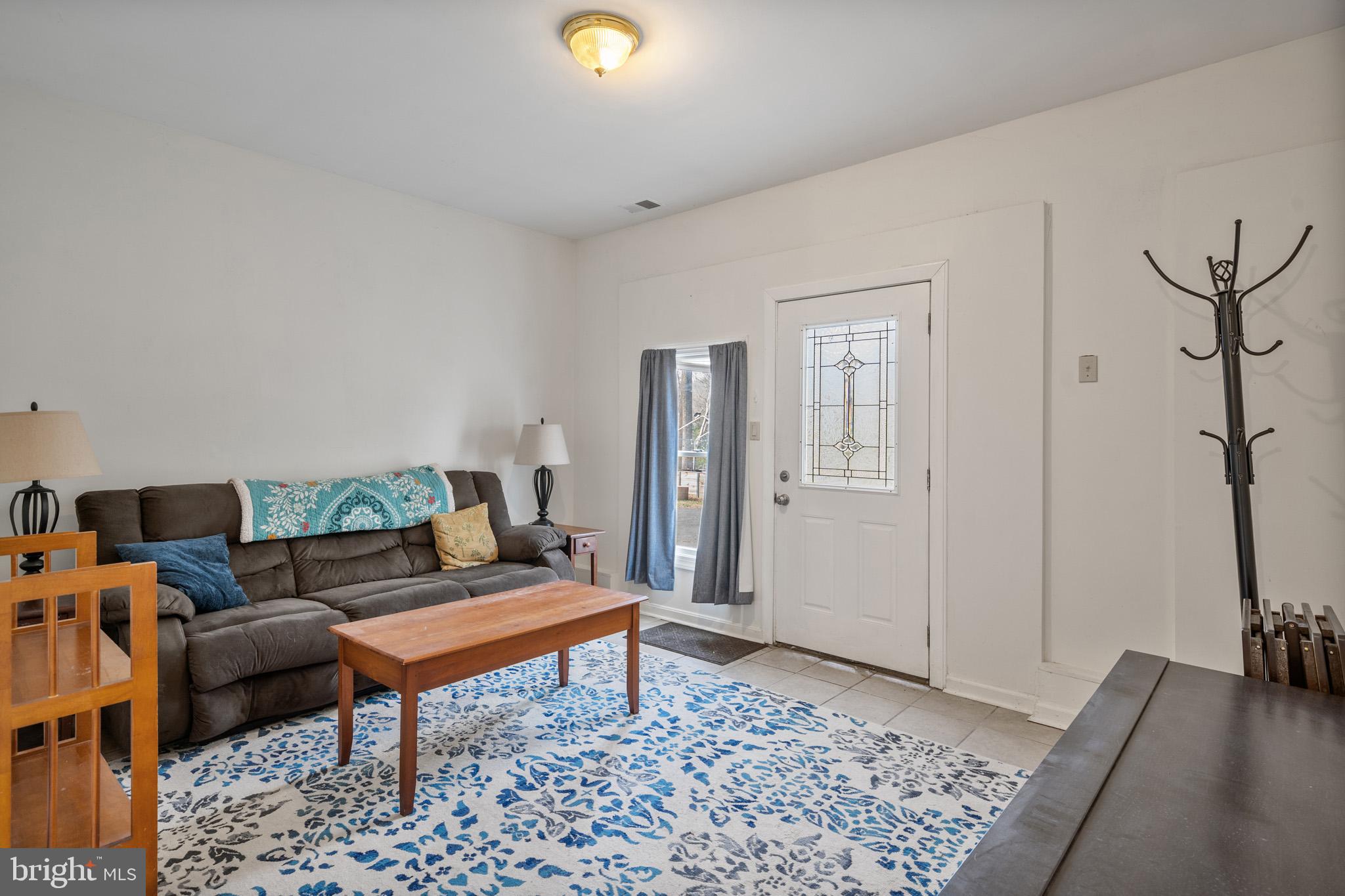 5918 Old Croom Station Road Upper Marlboro, MD 20772 - Photo 54 of 89 a living room with furniture and a rug