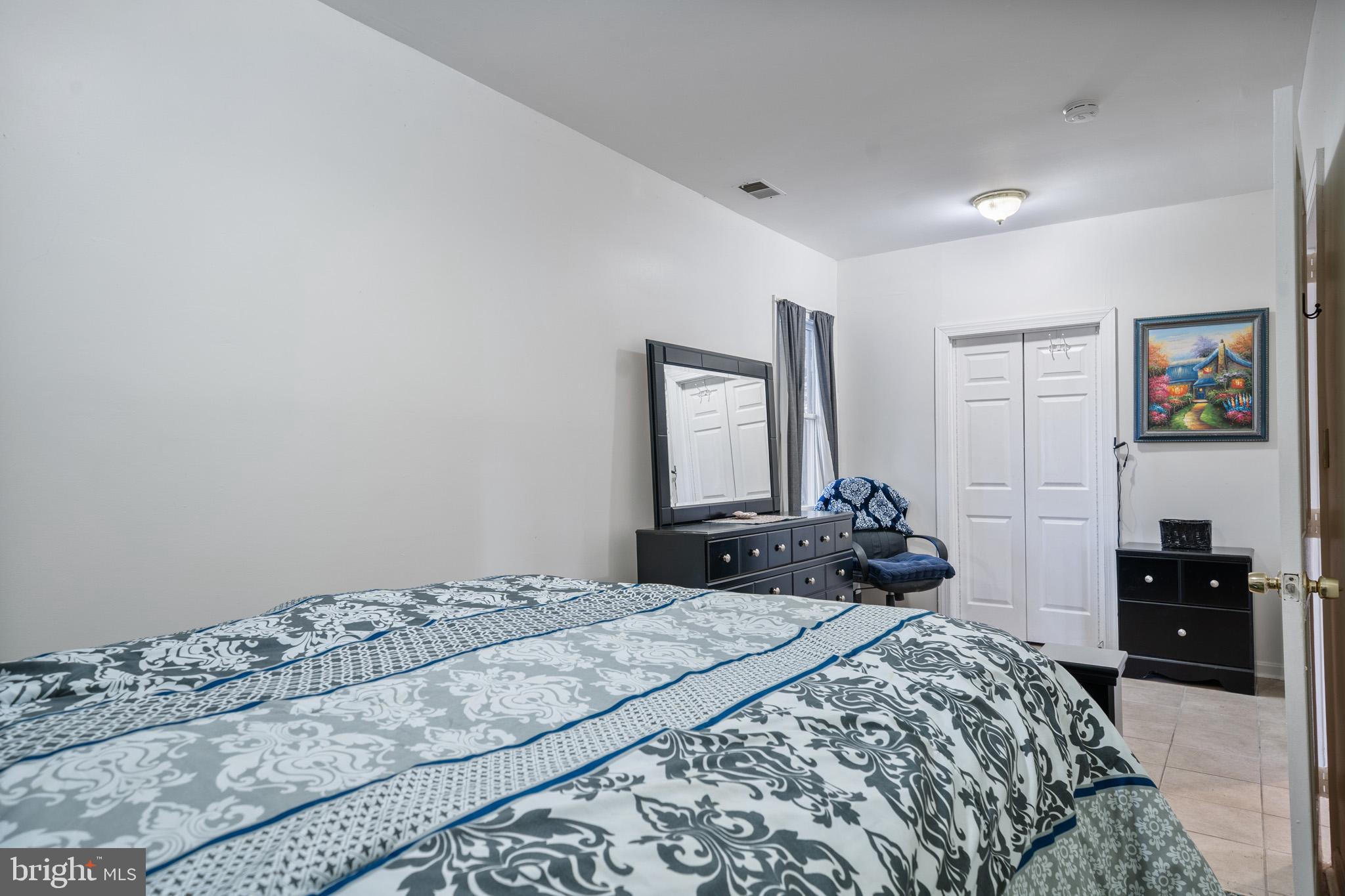 5918 Old Croom Station Road Upper Marlboro, MD 20772 - Photo 58 of 89 a bedroom with a bed and a large mirror
