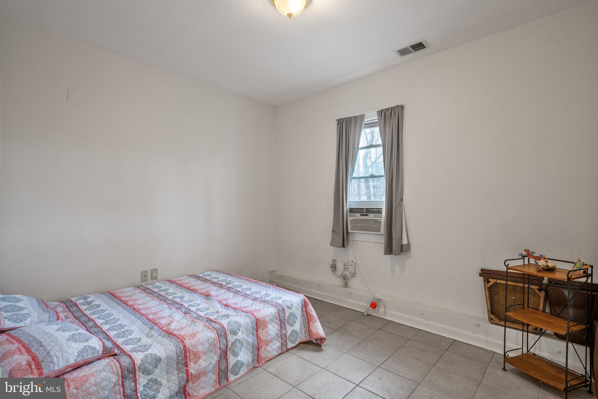 5918 Old Croom Station Road Upper Marlboro, MD 20772 - Photo 59 of 89 a bedroom with a bed and a window