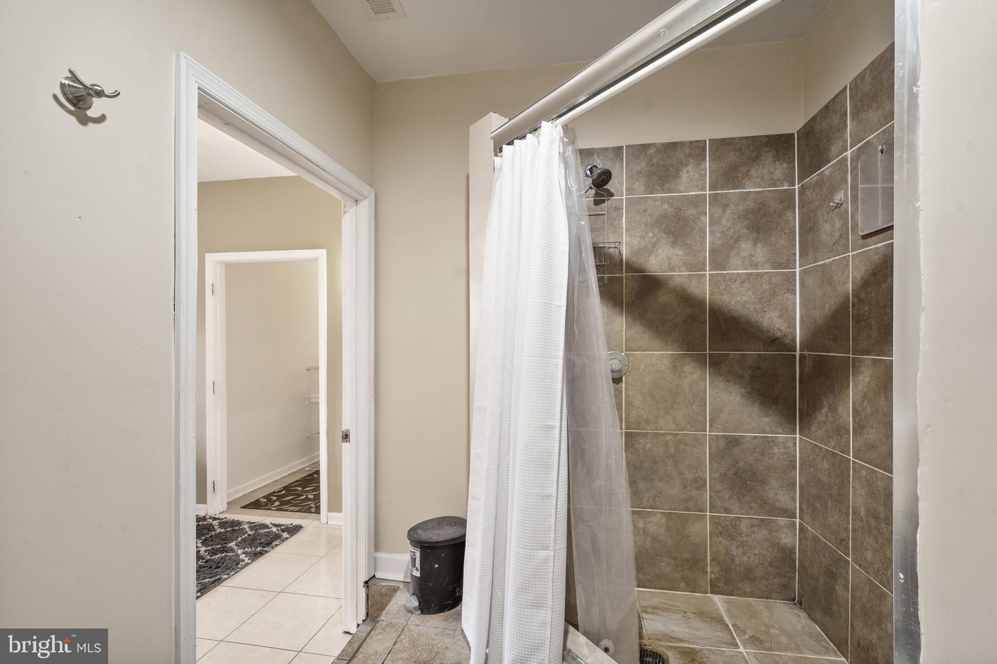 5918 Old Croom Station Road Upper Marlboro, MD 20772 - Photo 61 of 89 a bathroom with a shower and a sink