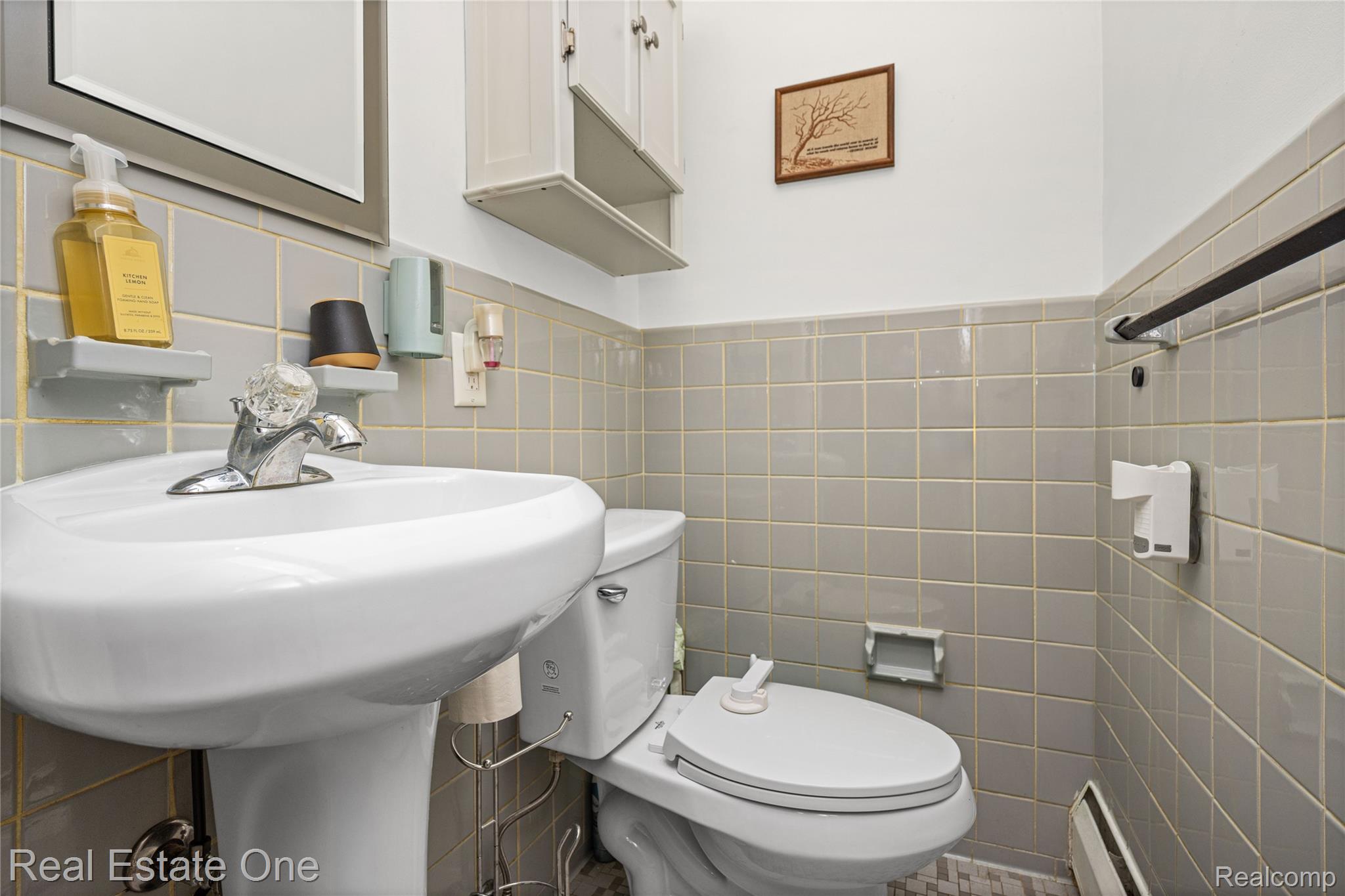 2810 Walbridge Drive Rochester, MI 48307 - Photo 37 of 58 Pedestal sink with chrome faucet, ceramic square wall tiling, and a built-in wall cabinet with shelving