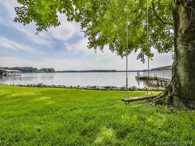 643 Isle Of Pines Road Mooresville, NC 28117 - Photo 10 of 14 a view of a lake with houses in the back