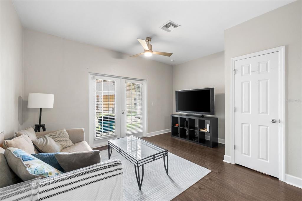2927 Southwest 35th Place, Unit 113 Gainesville, FL 32608 - Photo 7 of 27 a living room with furniture and a flat screen tv