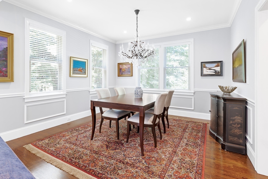 1332 Great Plain Avenue Needham, MA 02492 - Photo 12 of 42 a dining room with wooden floor a chandelier a wooden table and chairs