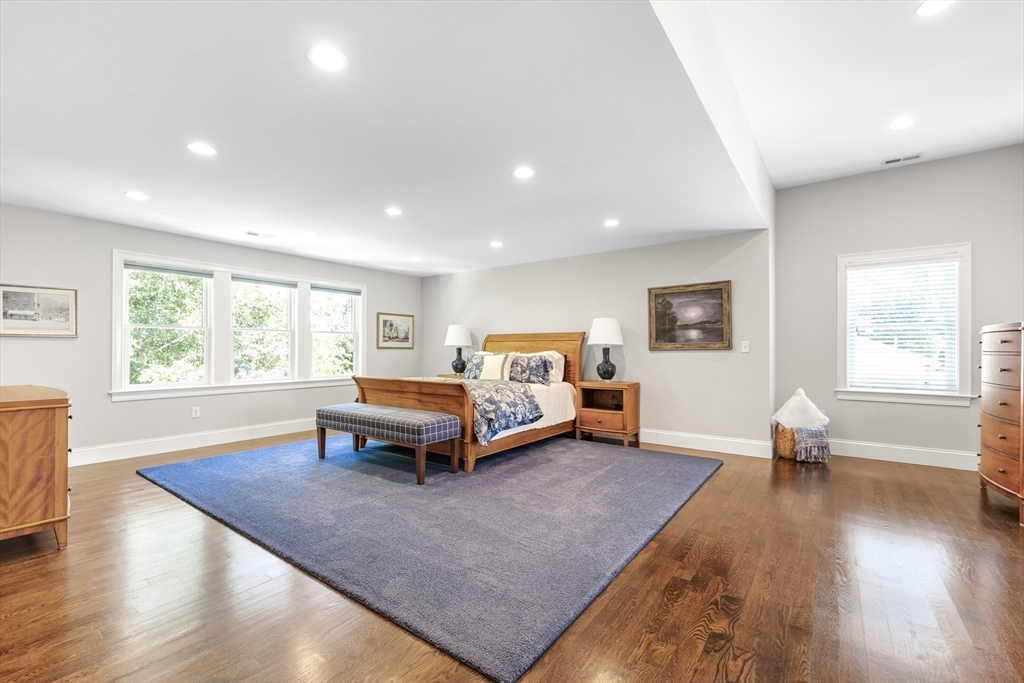 1332 Great Plain Avenue Needham, MA 02492 - Photo 17 of 42 a spacious bedroom with a bed and wooden floor